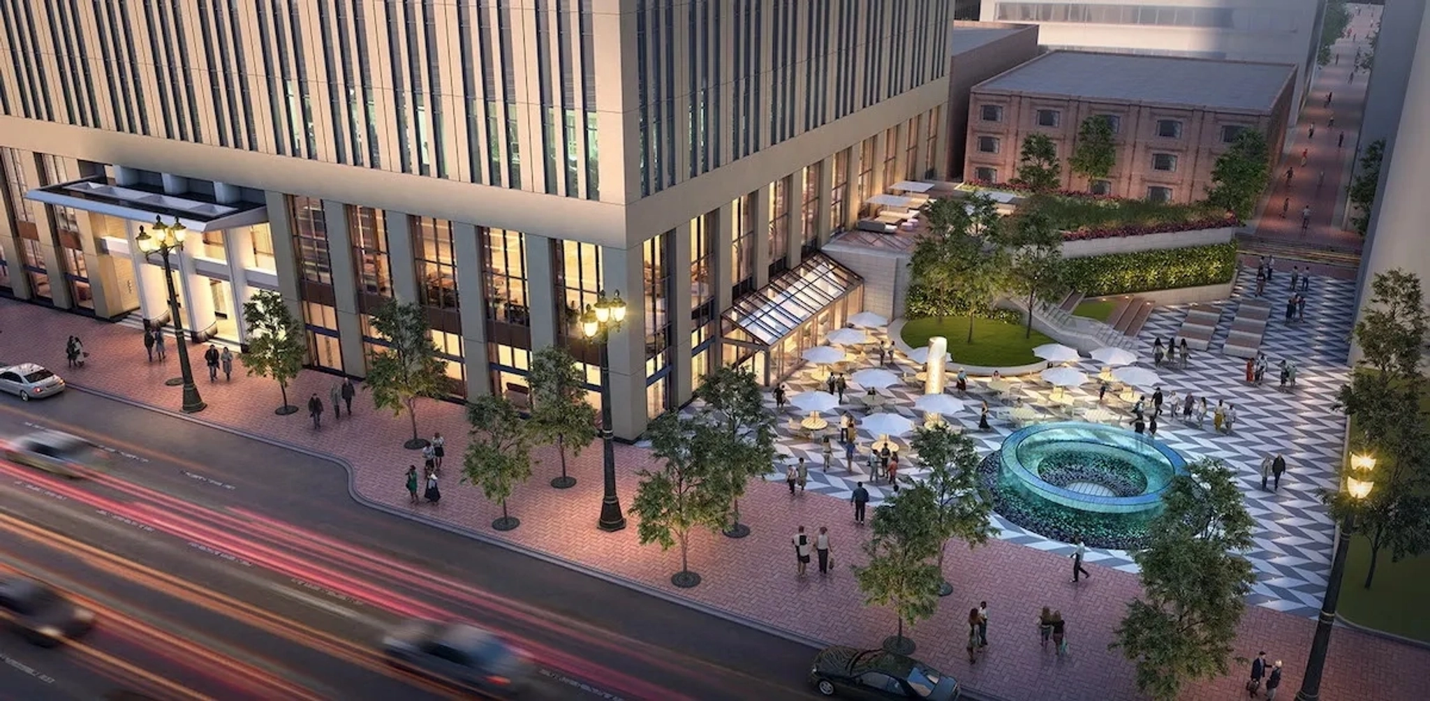 Aerial view of an urban plaza with a fountain, outdoor seating, and people walking. Nearby streets in San Francisco have light traffic. The plaza is bordered by a modern building with tall windows that could easily house an inspiring workspace.