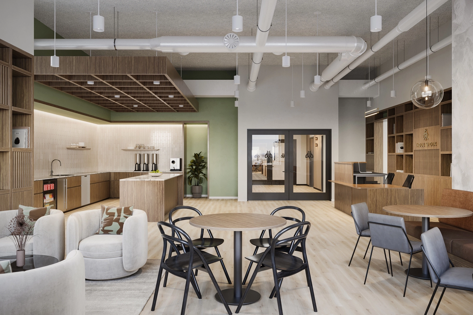 Modern office workspace with mixed seating, kitchen area, and exposed ceiling pipes. Neutral and green color palette with natural wood accents.