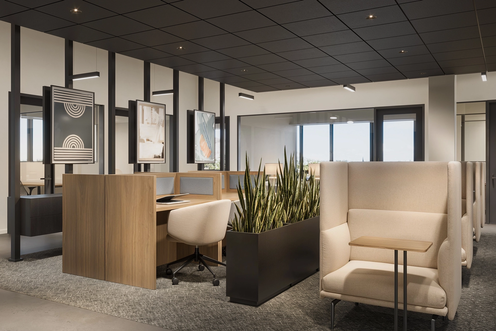 Modern workspace in Phoenix featuring wooden desks, upholstered chairs, and partitioning plants. The neutral tones and wall art create a well-lit environment ideal for productivity and collaboration.