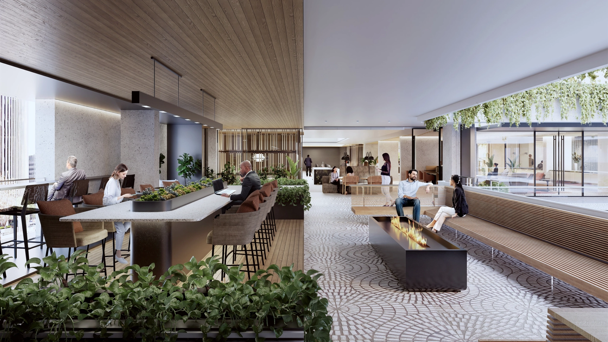 A modern indoor courtyard in San Francisco serves as a dynamic coworking space, featuring a long table, chairs, benches, lush plants, and a fire feature. People are seated and walking around this bright, open area that seamlessly blends natural wood elements with an inspiring workspace vibe.