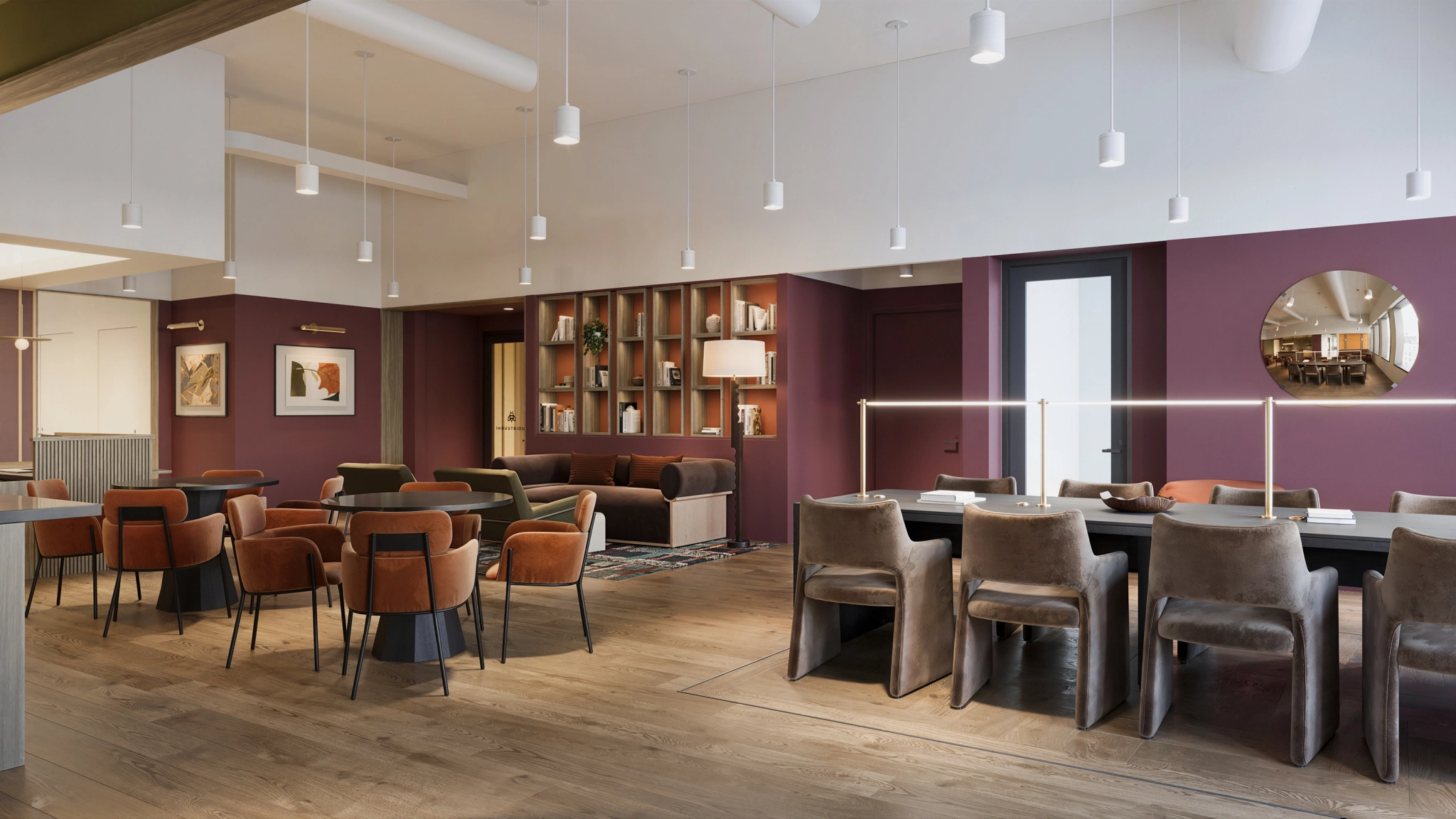 Modern lounge with purple walls, wooden floors, mixed seating including tables, chairs, and sofas—perfect for an office meeting room in New York. Features bookshelves and pendant lighting.