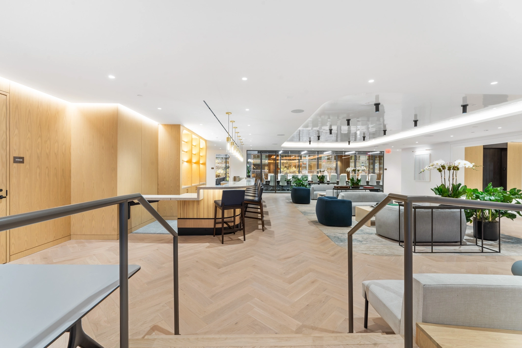 Modern New York office lobby with wooden flooring, contemporary seating, indoor plants, and bright lighting, featuring a reception desk and open lounge area.