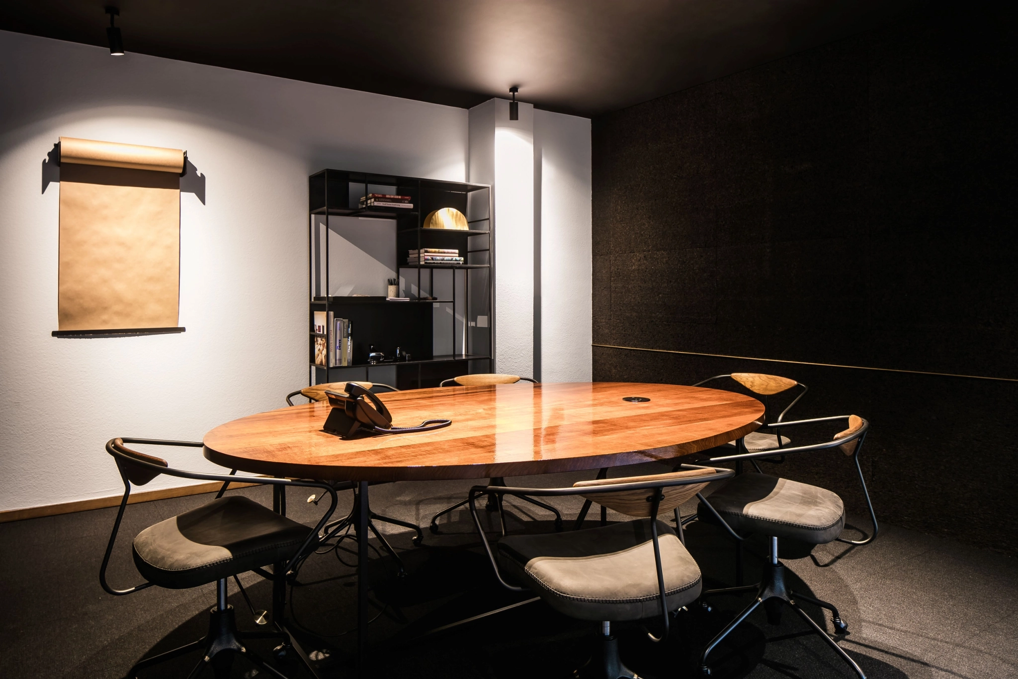 A meeting room with a wooden table and chairs.