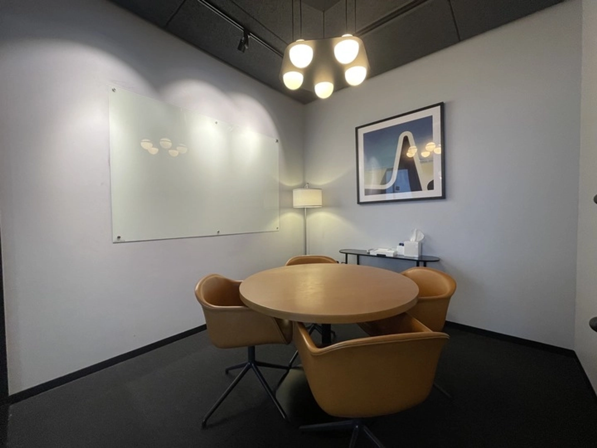 A meeting room with a table and chairs.