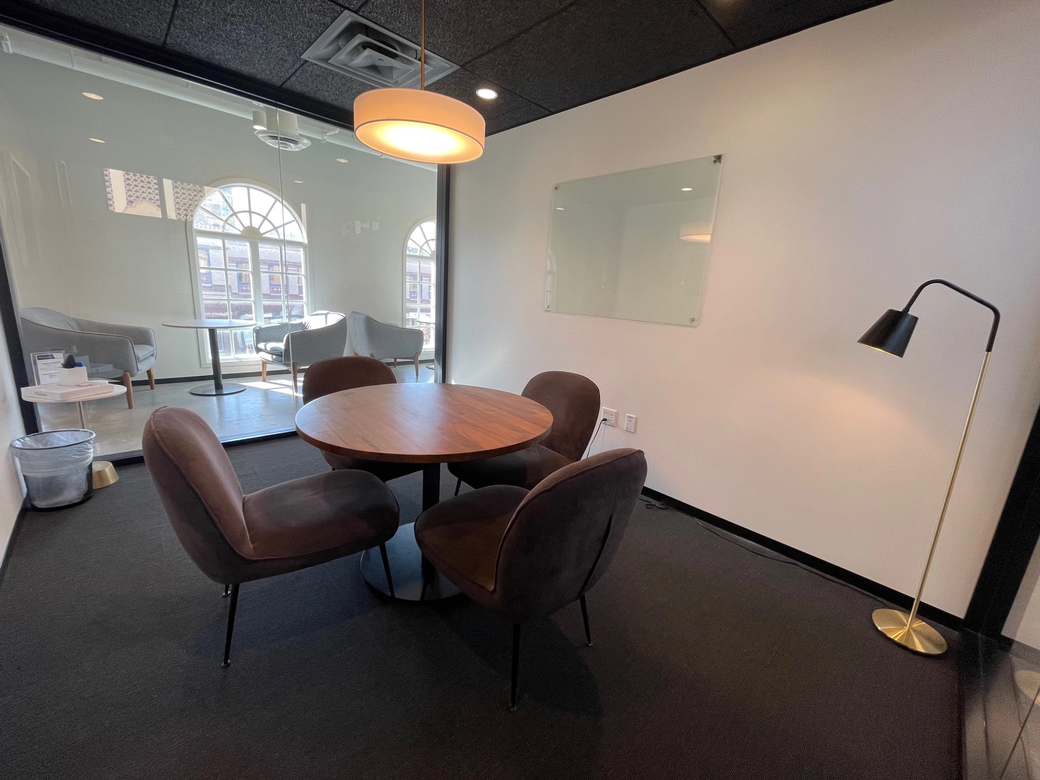 A Kansas City coworking meeting room with a round table and chairs.