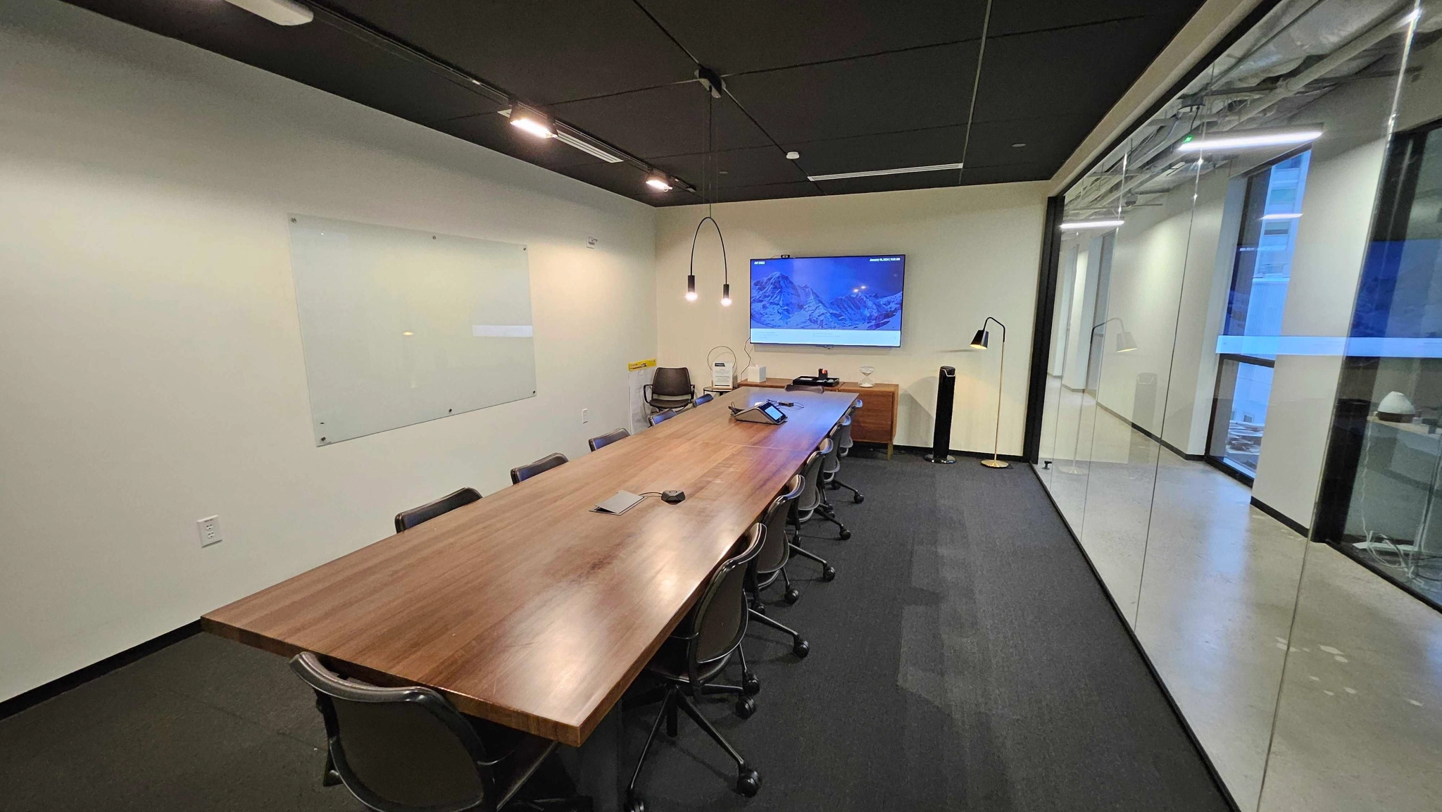 A coworking meeting room with a large table and chairs.