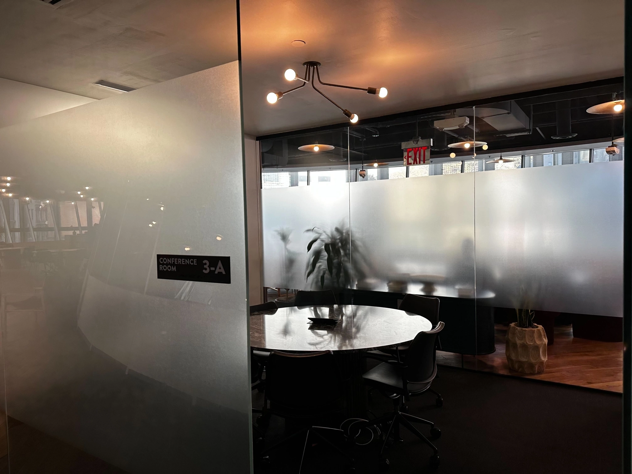 A conference room in a New York office with frosted glass walls.