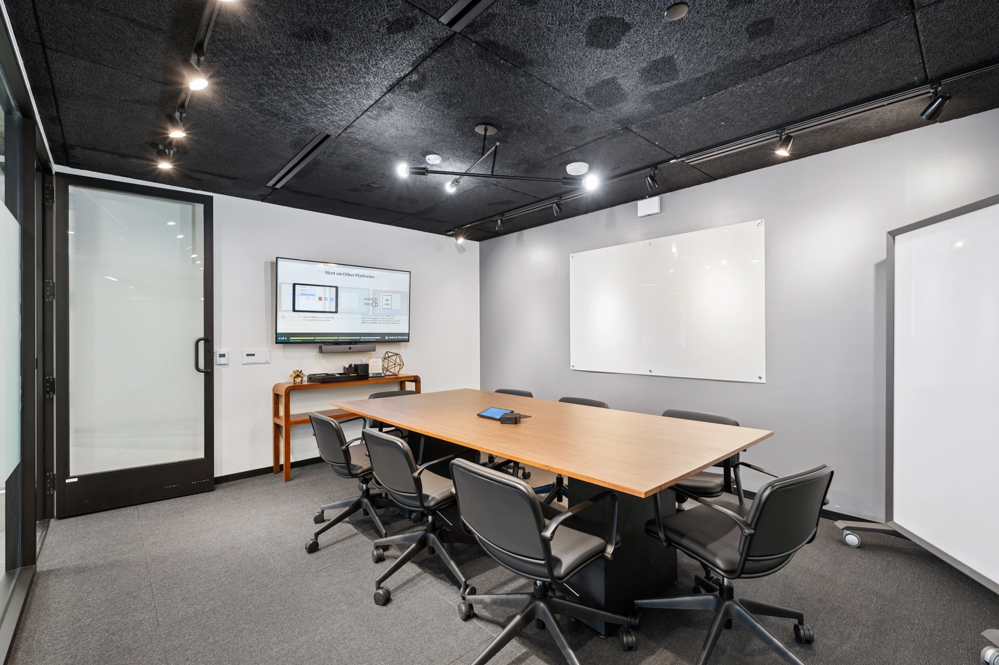 a large, bright meeting room with a large screen