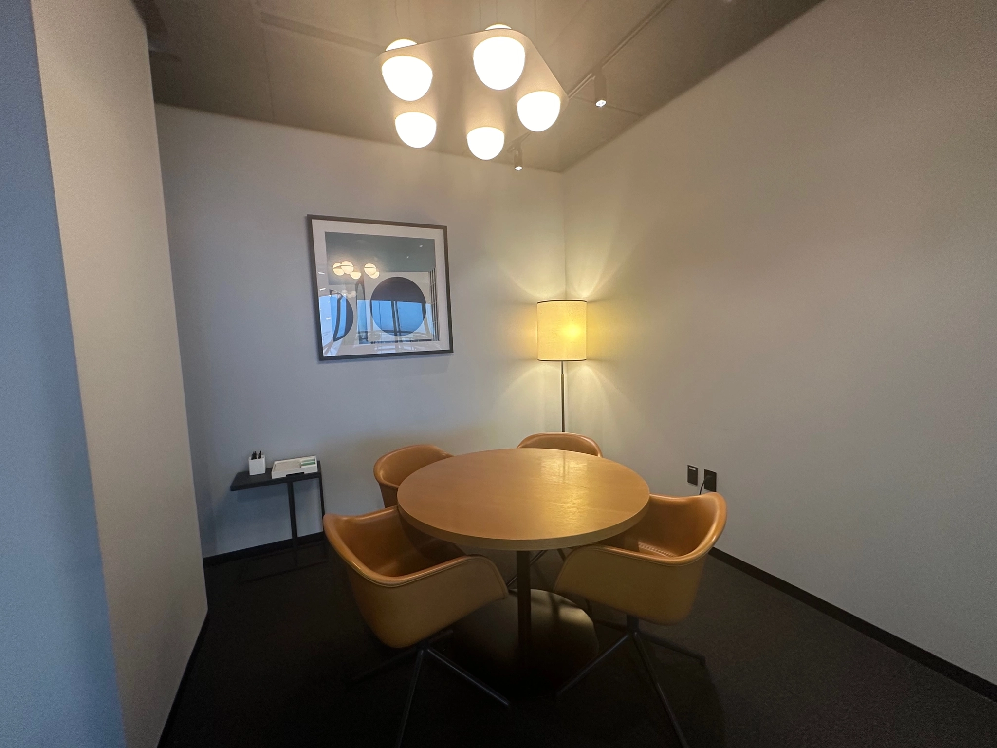 An office in Dallas with a table and chairs and a lamp.