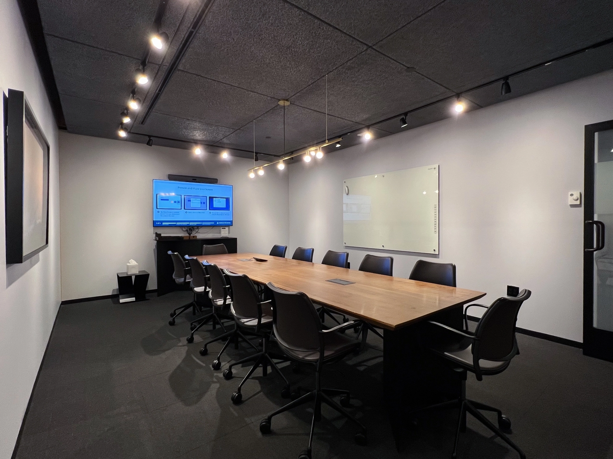 A spacious conference room in Minneapolis with a large table and comfortable chairs, perfect for office meetings or collaborative workspace.