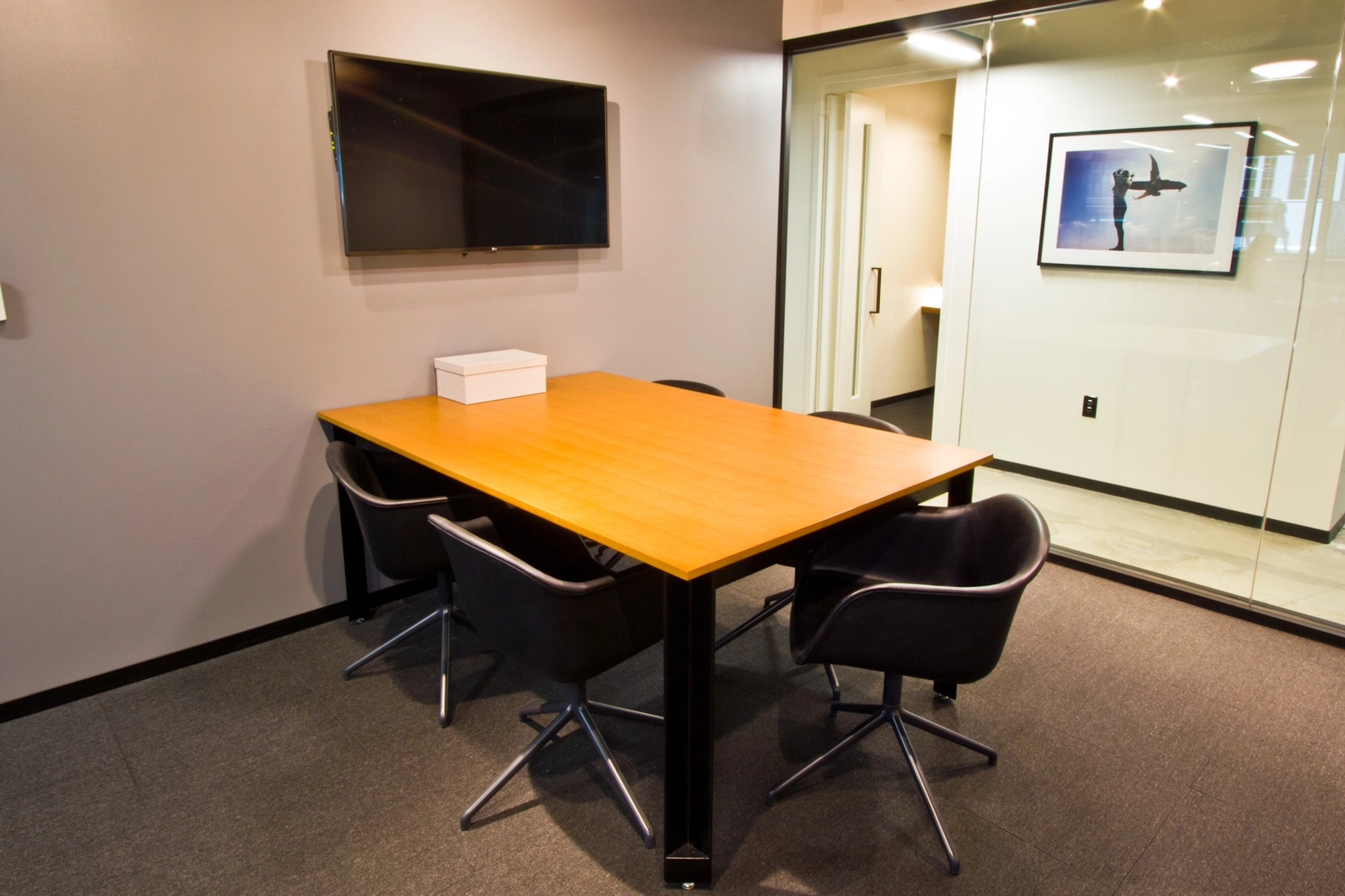 A conference room in an office, equipped with a table and chairs for meetings.