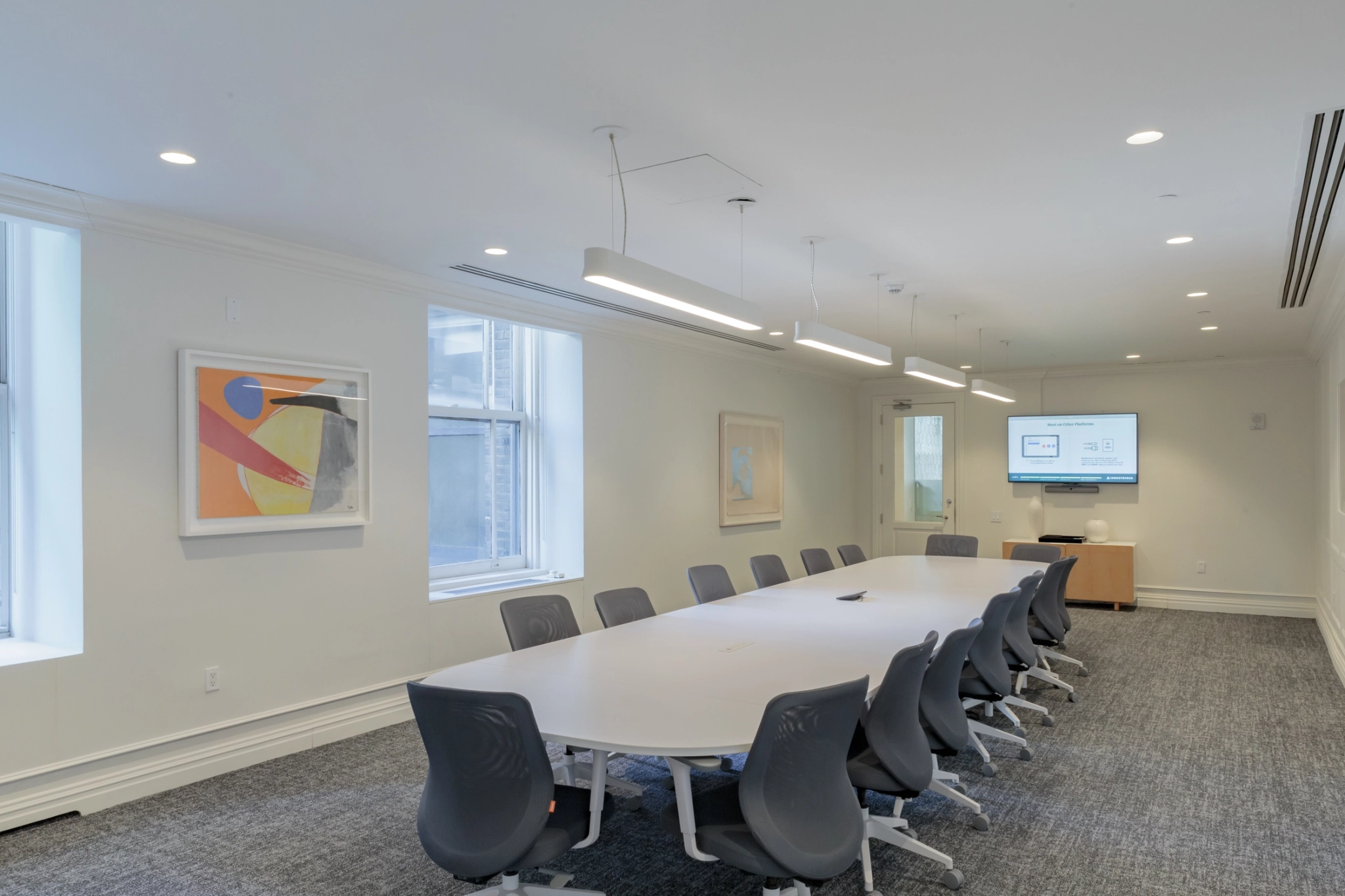 An office conference room in New York with a long table and chairs.