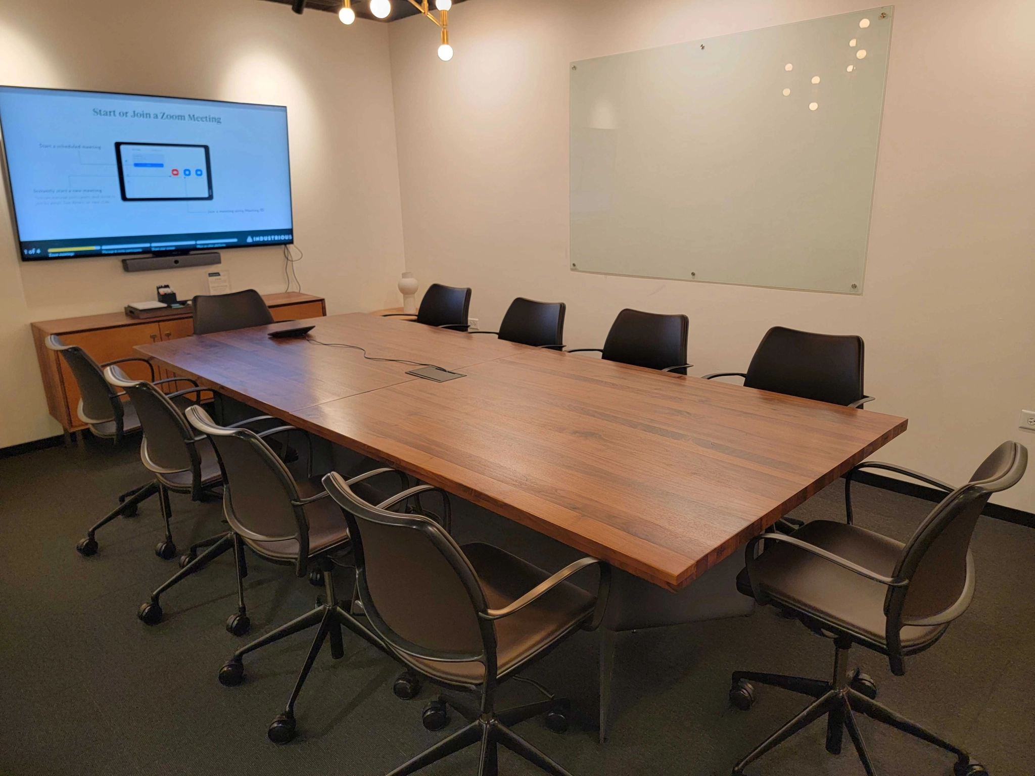 A coworking meeting room with a large table and chairs.