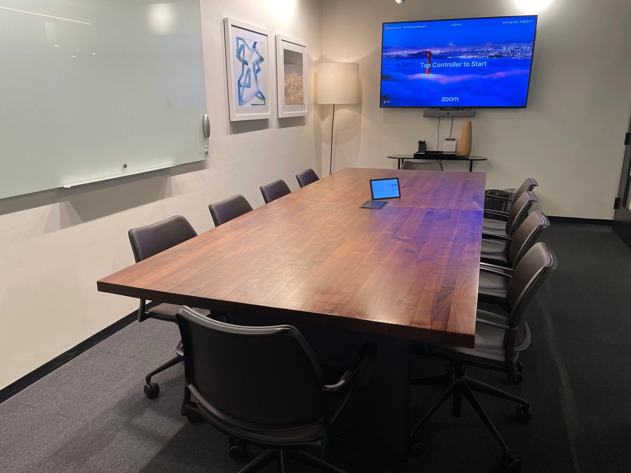 A coworking office space with a large table and chairs.