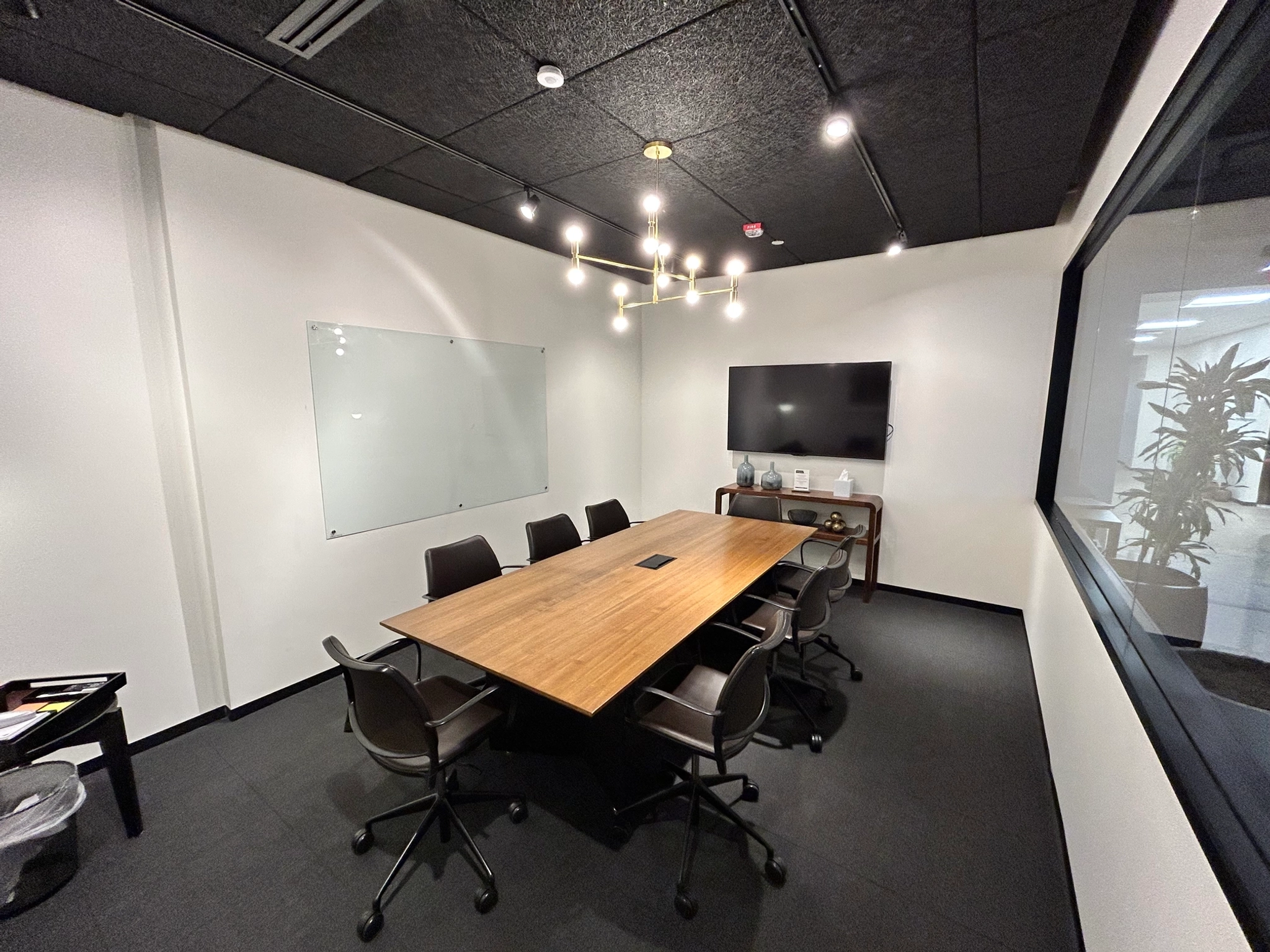 A coworking meeting room with a table and chairs.