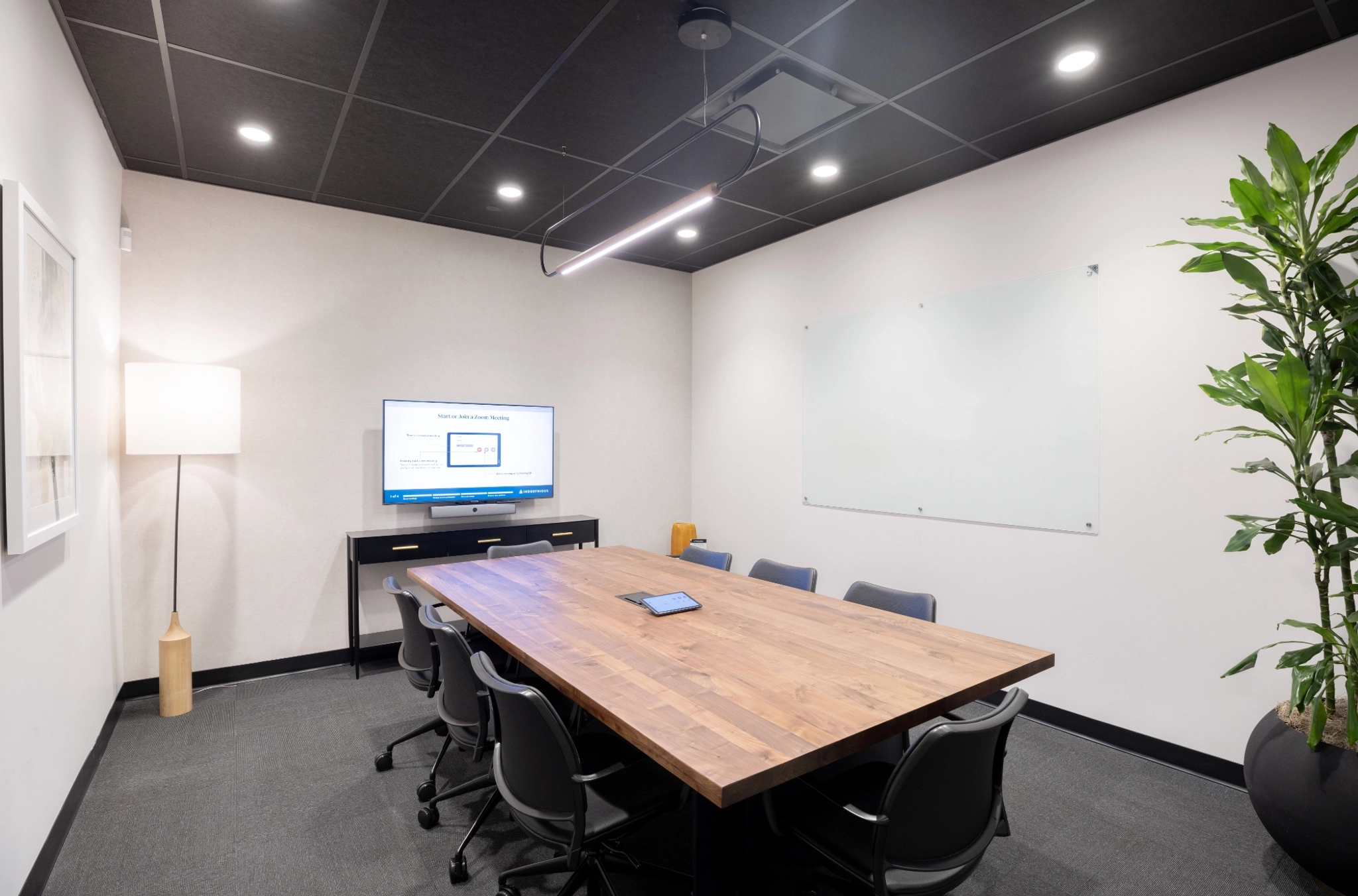 A meeting room in an office located in Houston, with a large table and chairs.