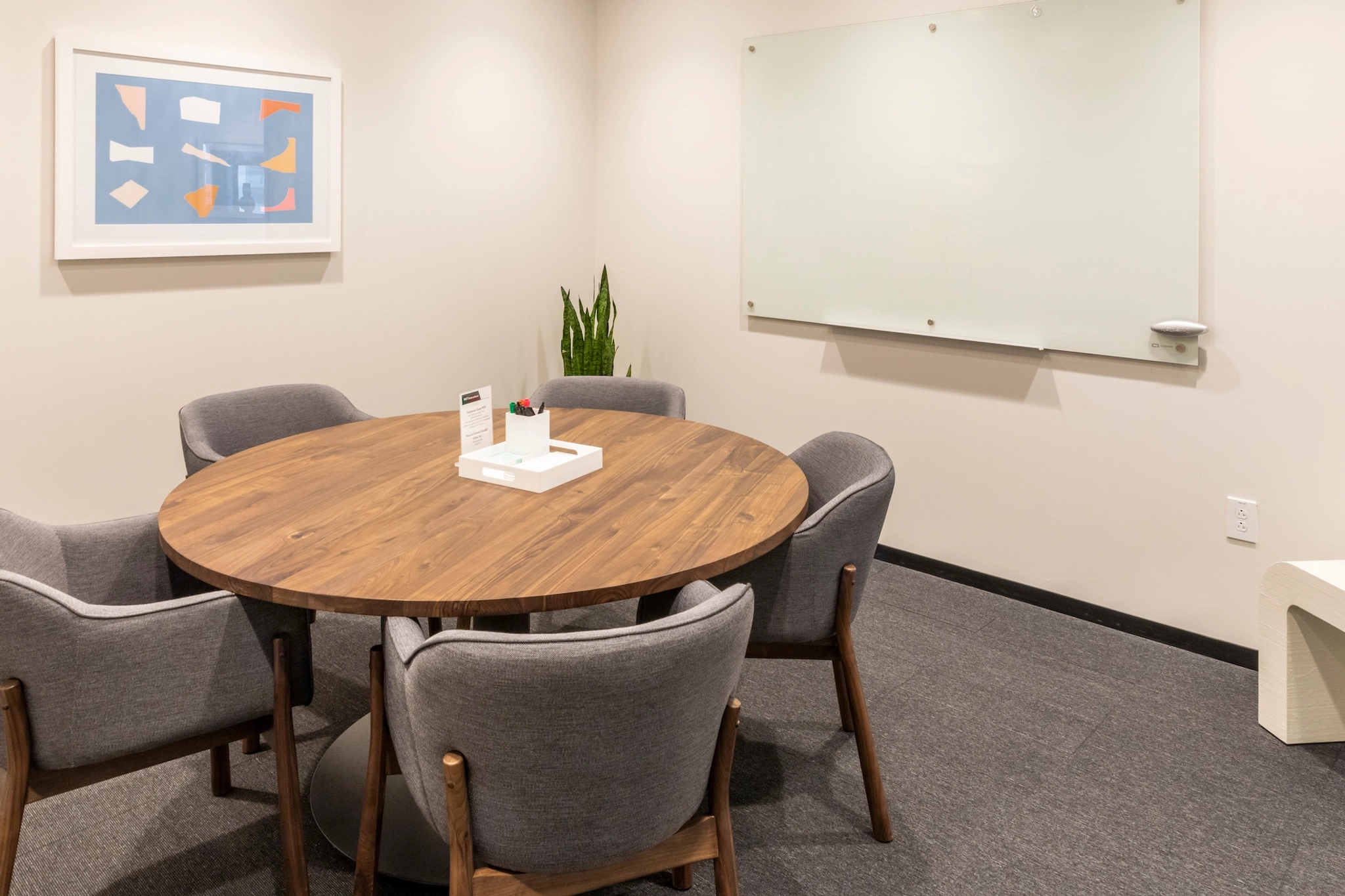 A coworking meeting room in Chapel Hill with a table and chairs.