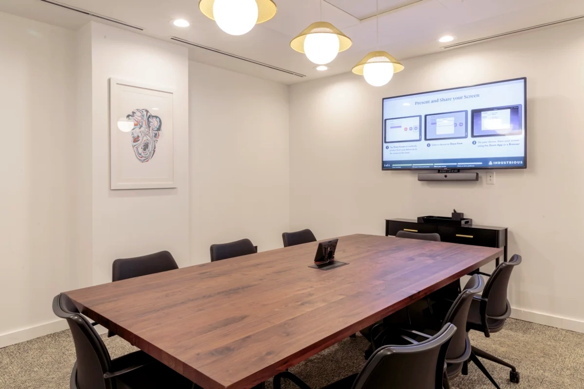 A coworking conference room space in New York, equipped with a TV on the wall.