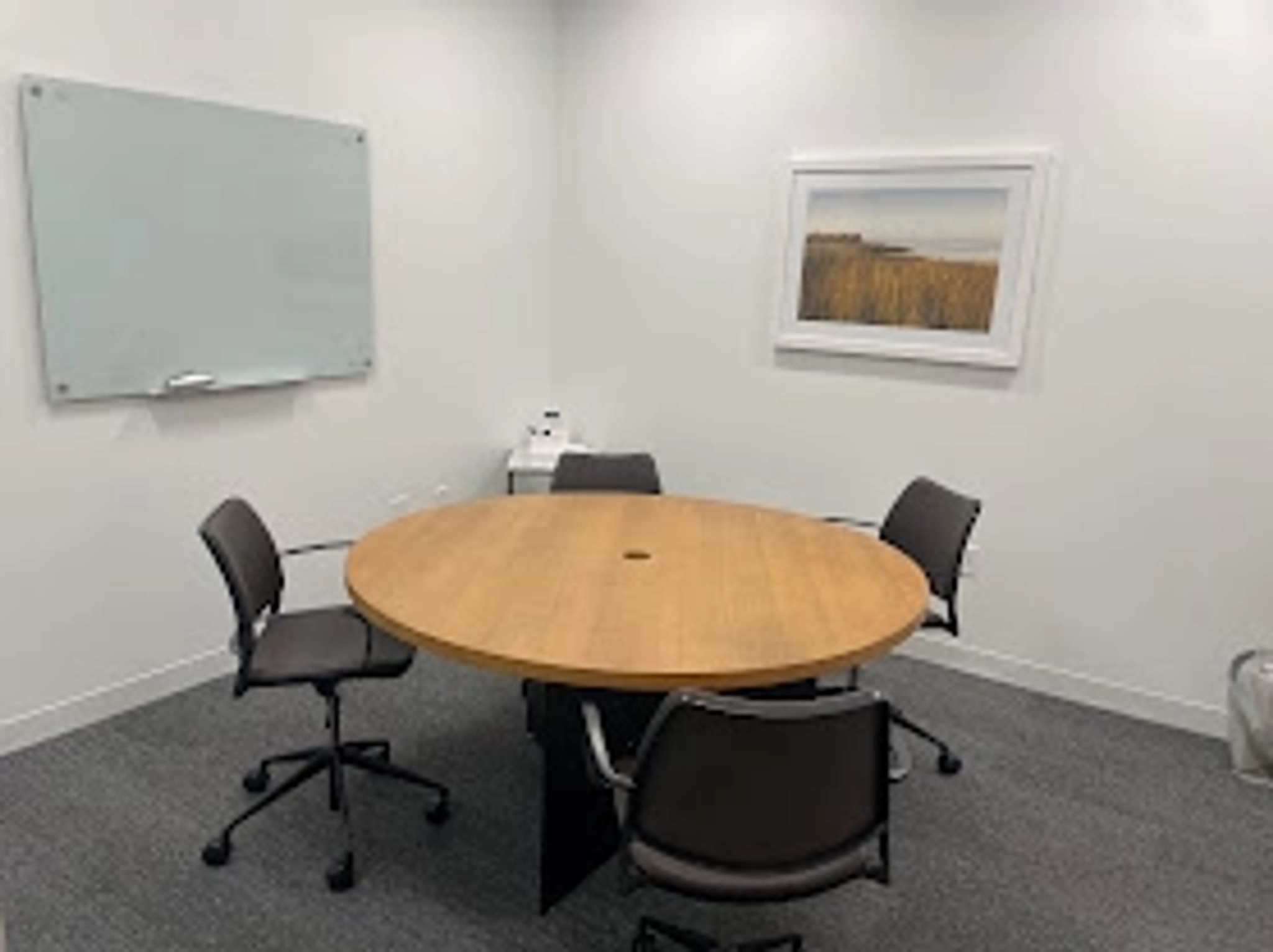 A workspace with a table and chairs in a meeting room in Atlanta.