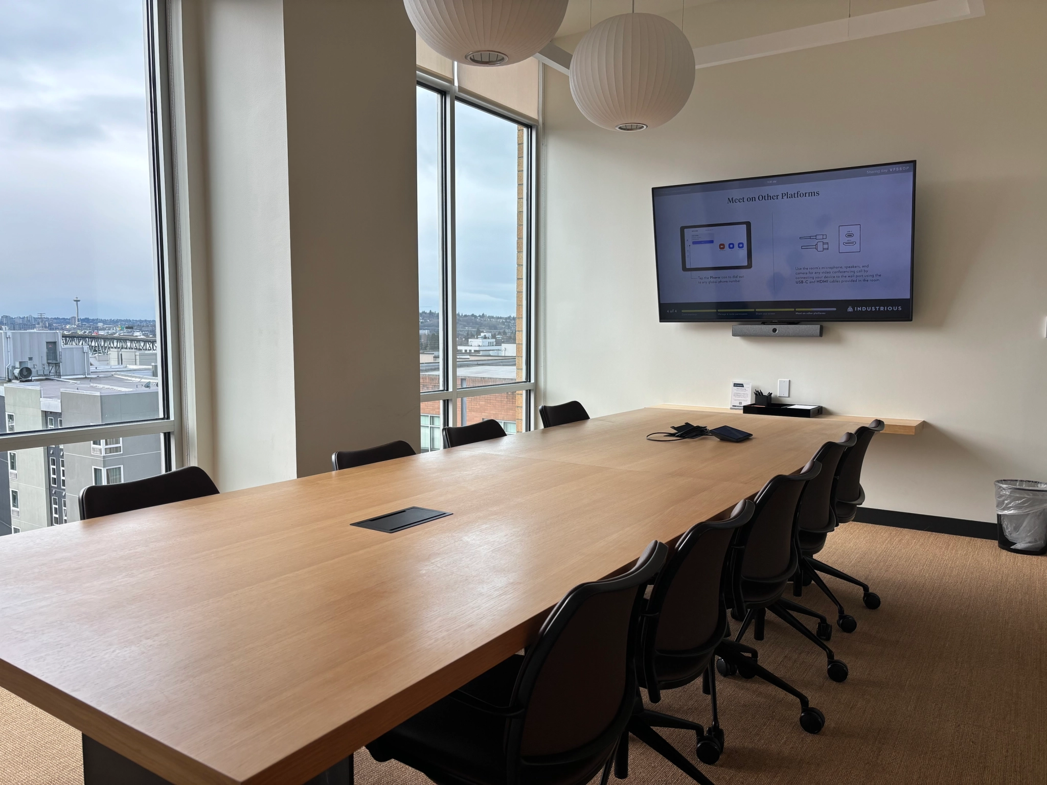 A meeting room in an office with a large TV on the wall.