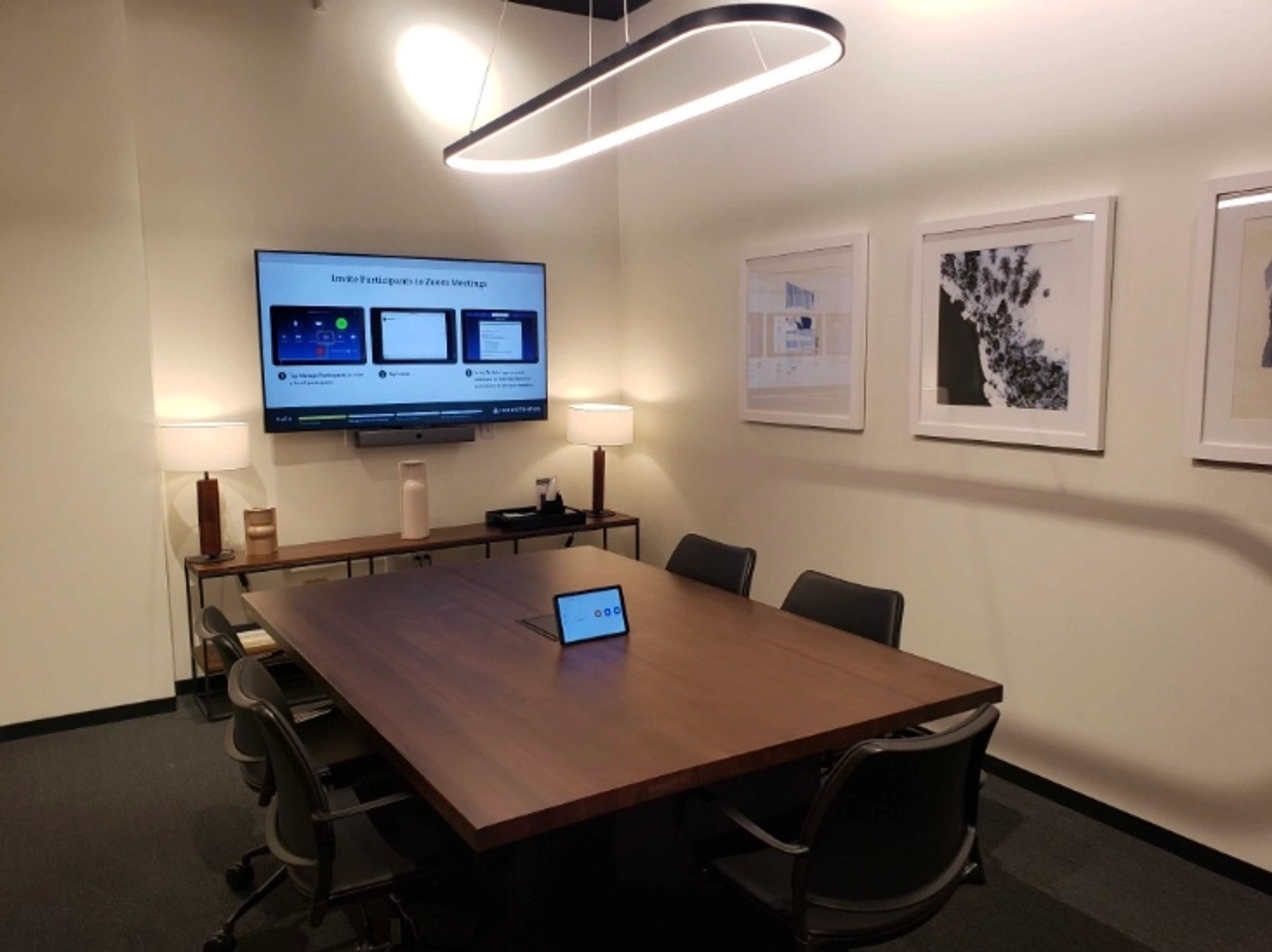 A coworking meeting room equipped with a TV on the wall, ideal for office gatherings and conferences.