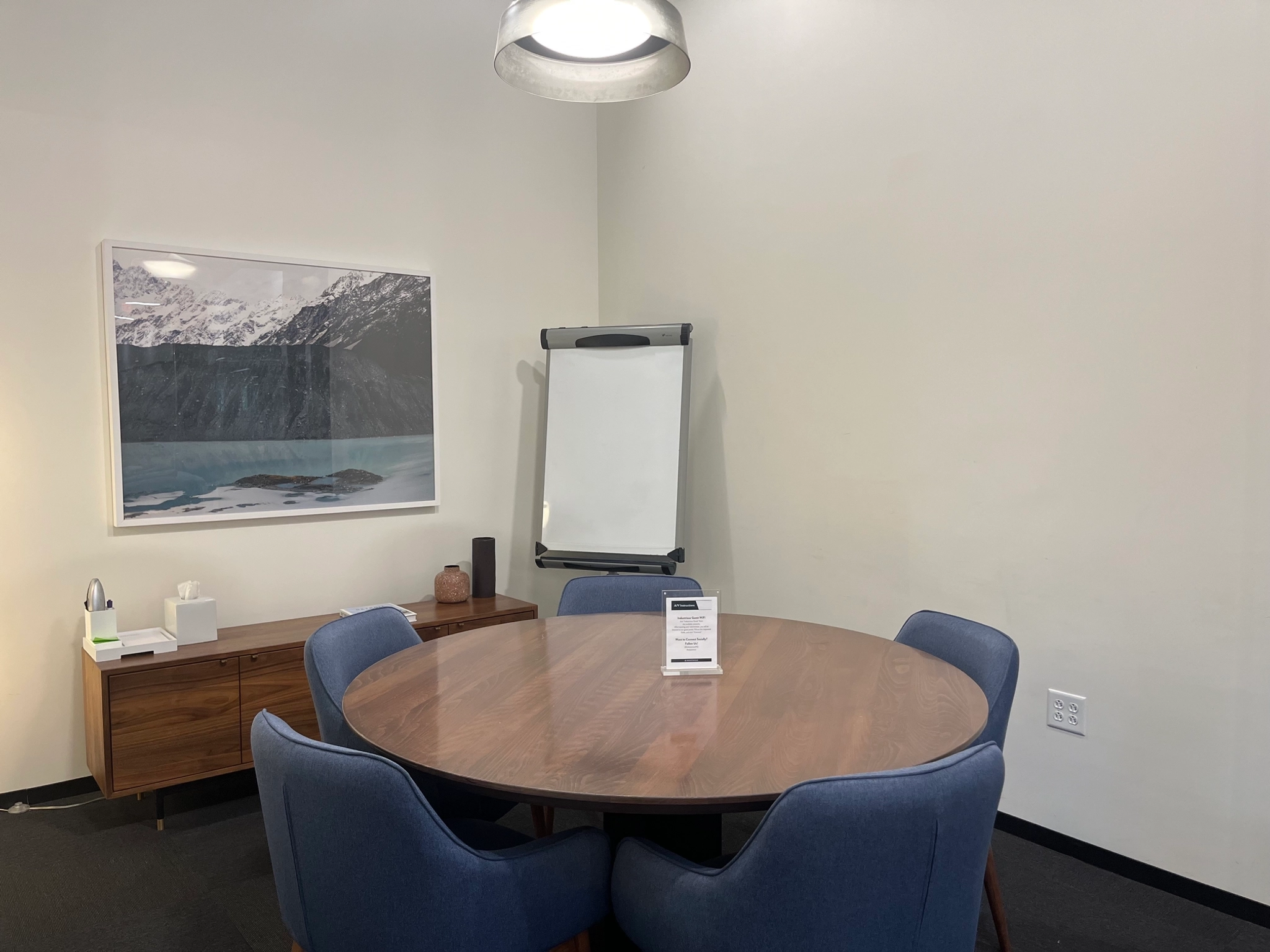 A meeting room with a round table and chairs in Scottsdale.