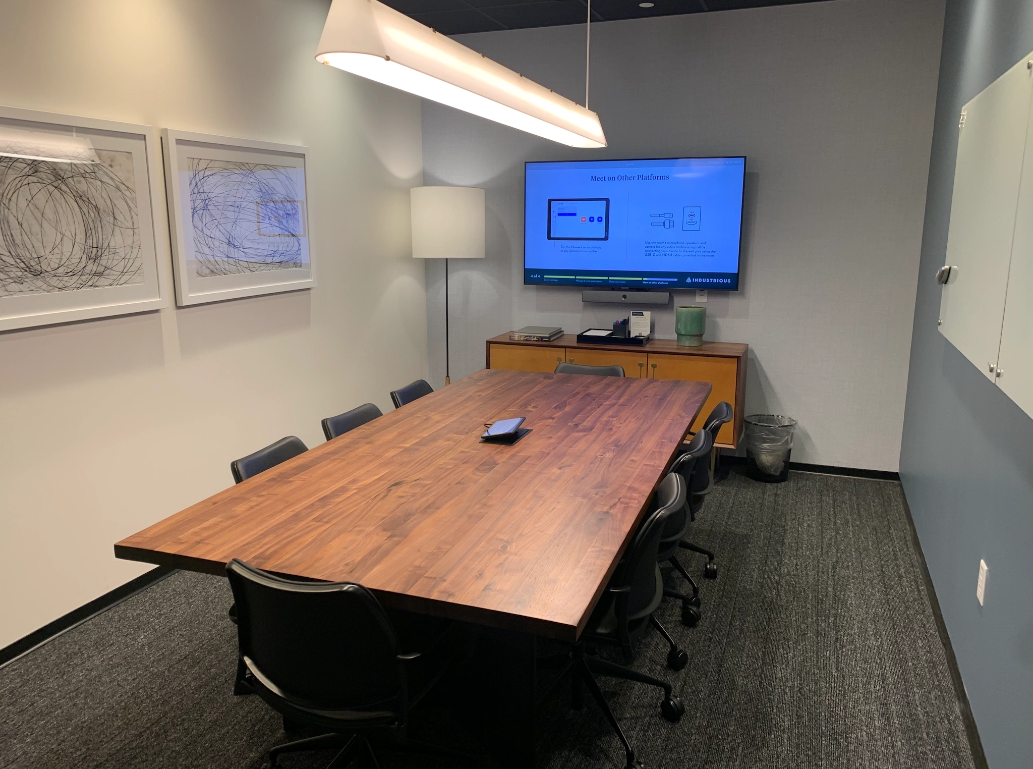 A spacious conference room in Seattle equipped with a large table and comfortable chairs for coworking or hosting productive meetings.