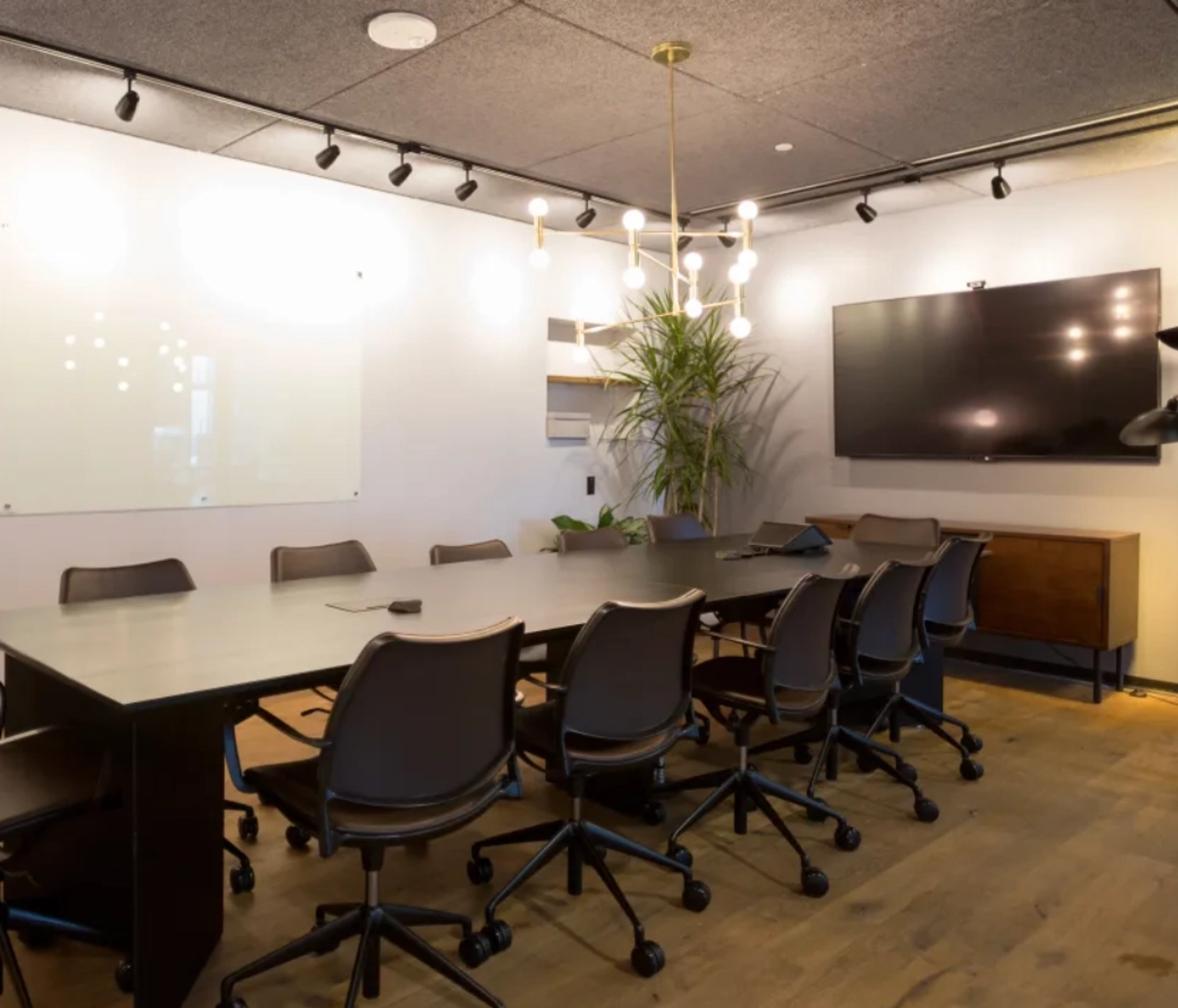 A spacious conference room in Atlanta, equipped with a large table and chairs for productive meetings and a comfortable workspace.