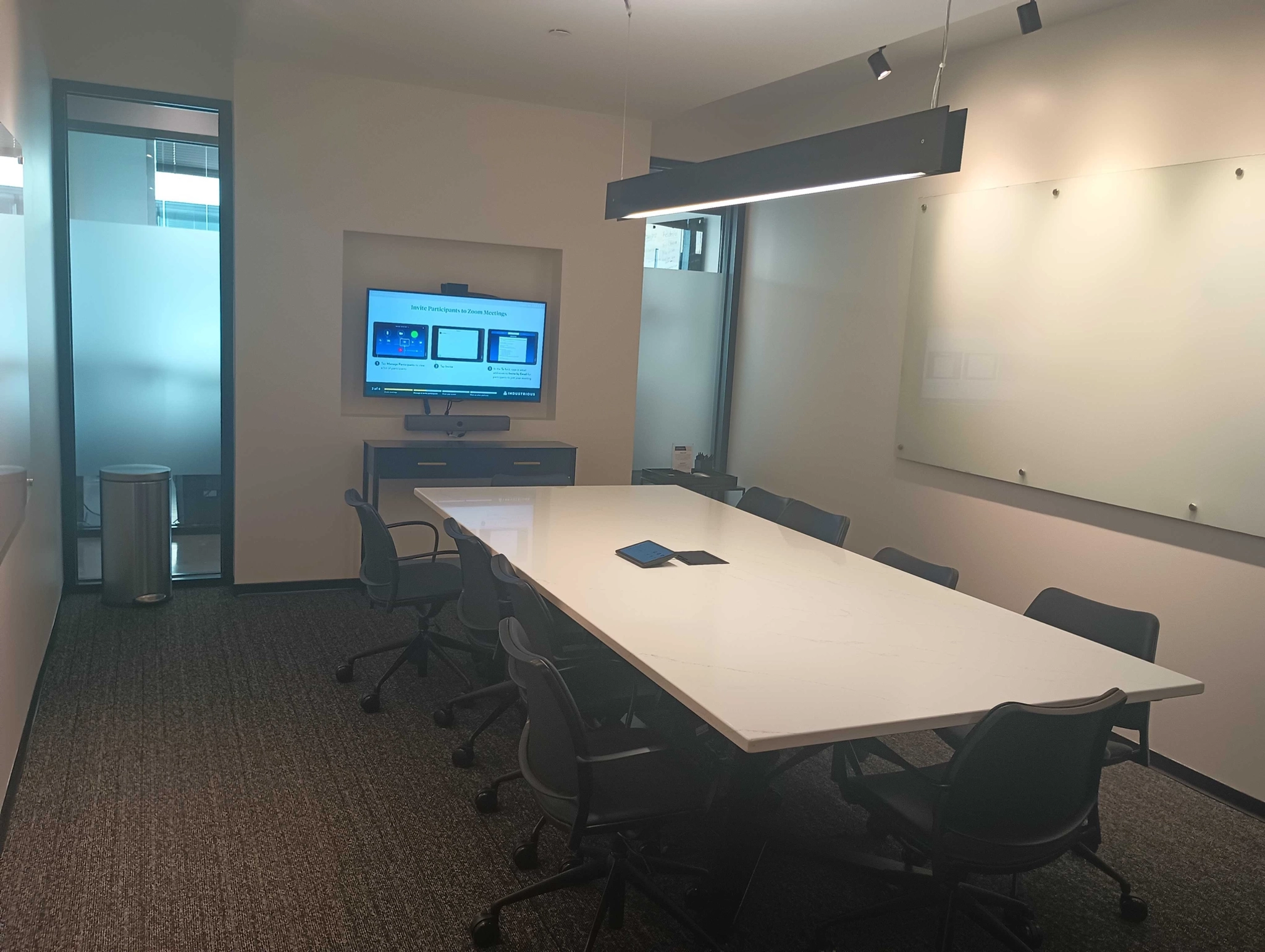 An office conference room in Raleigh with a white board and tv, creating an ideal workspace.