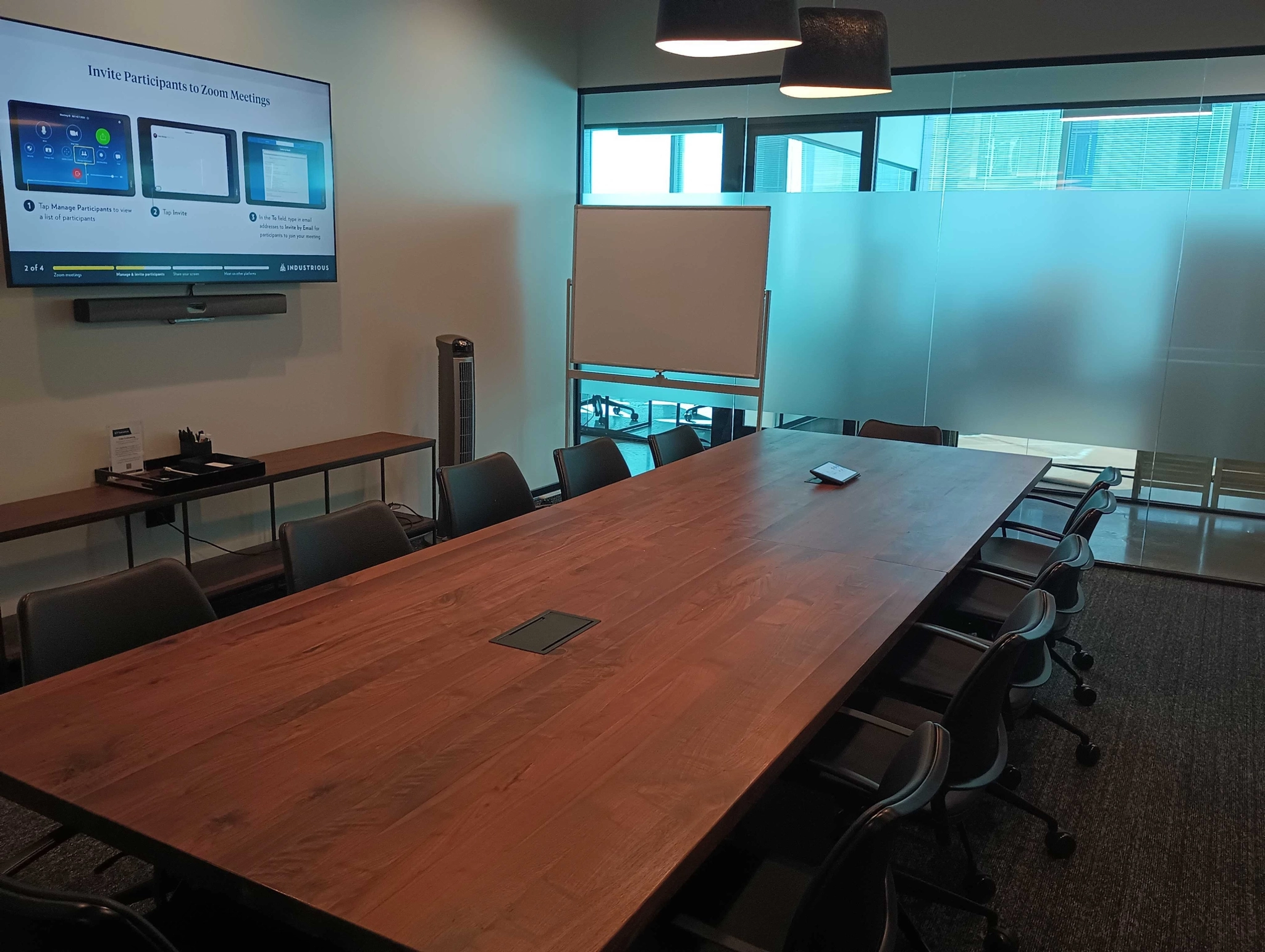 A meeting room in an office space in Raleigh equipped with a large screen TV.