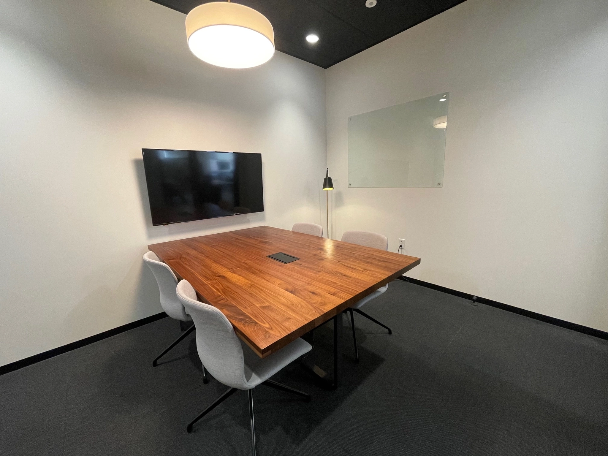 An office conference room with a table and chairs, perfect for coworking or team meetings.