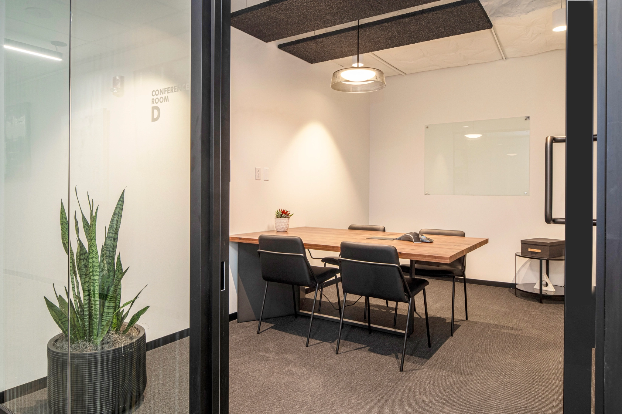 An office conference room with a table and chairs.