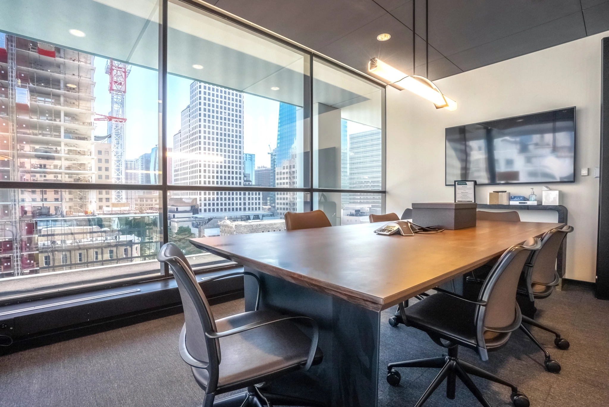 A coworking space with a large window overlooking a city.