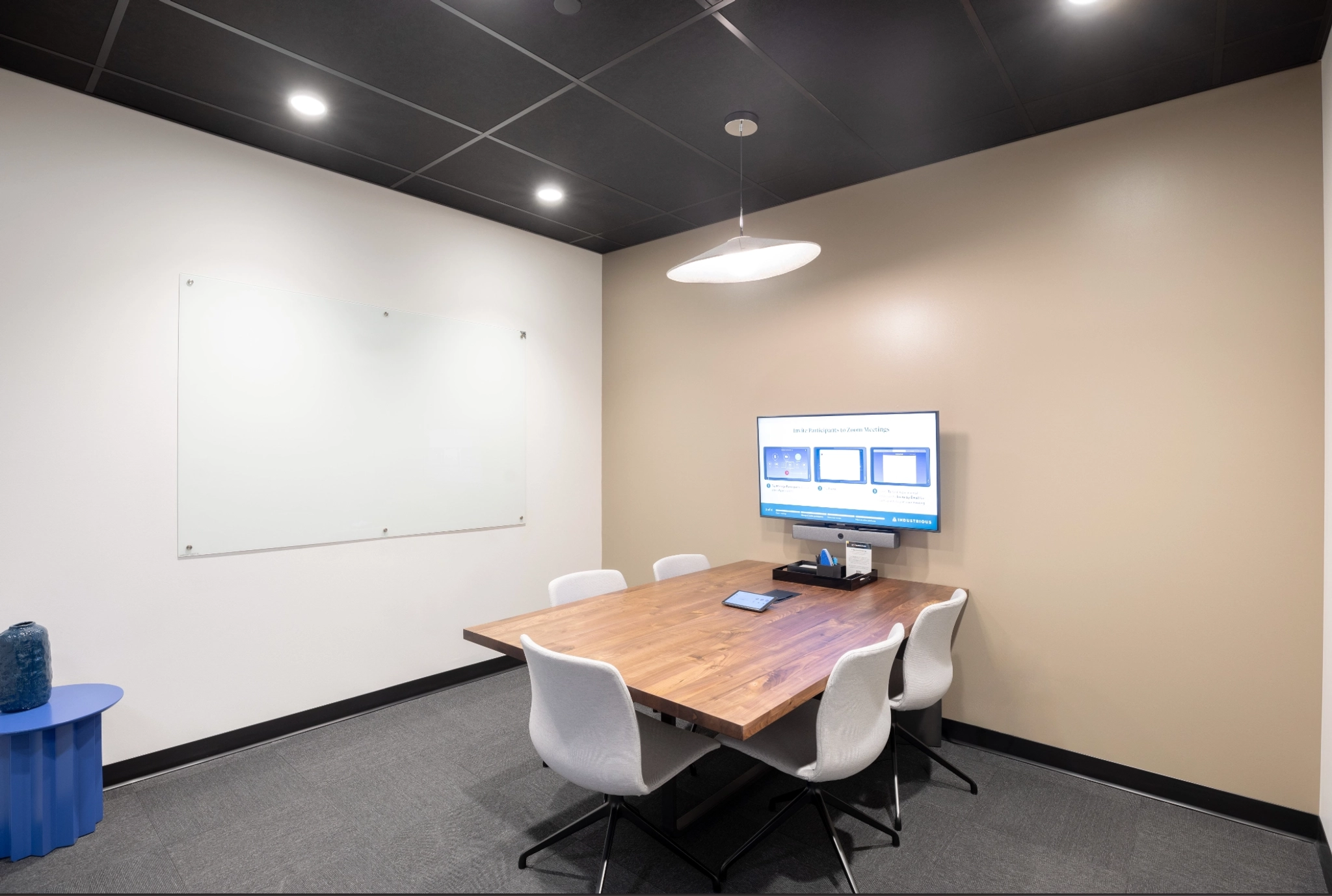 An office conference room with a table, chairs, and a TV in Houston.