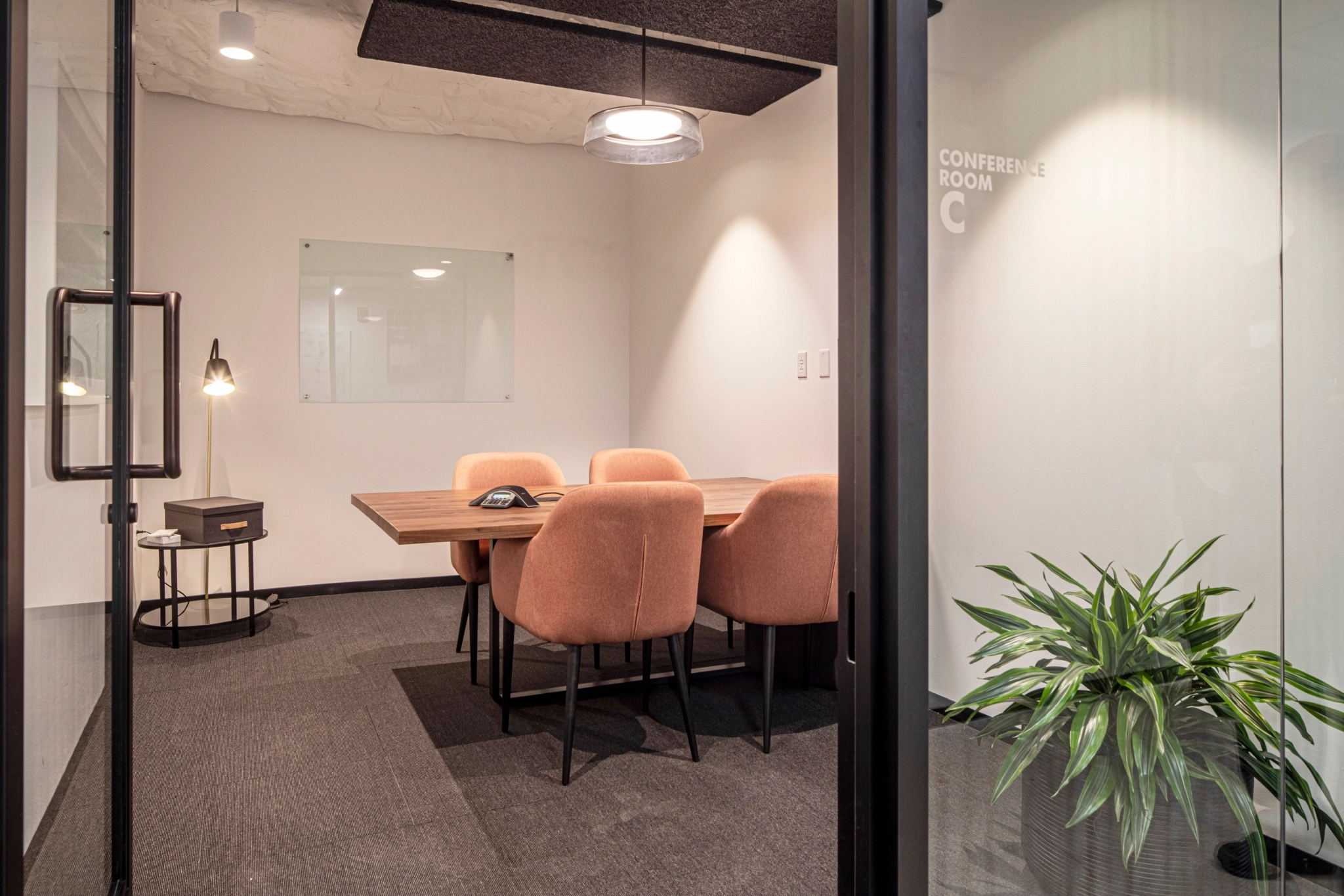 A meeting room with a table and chairs.