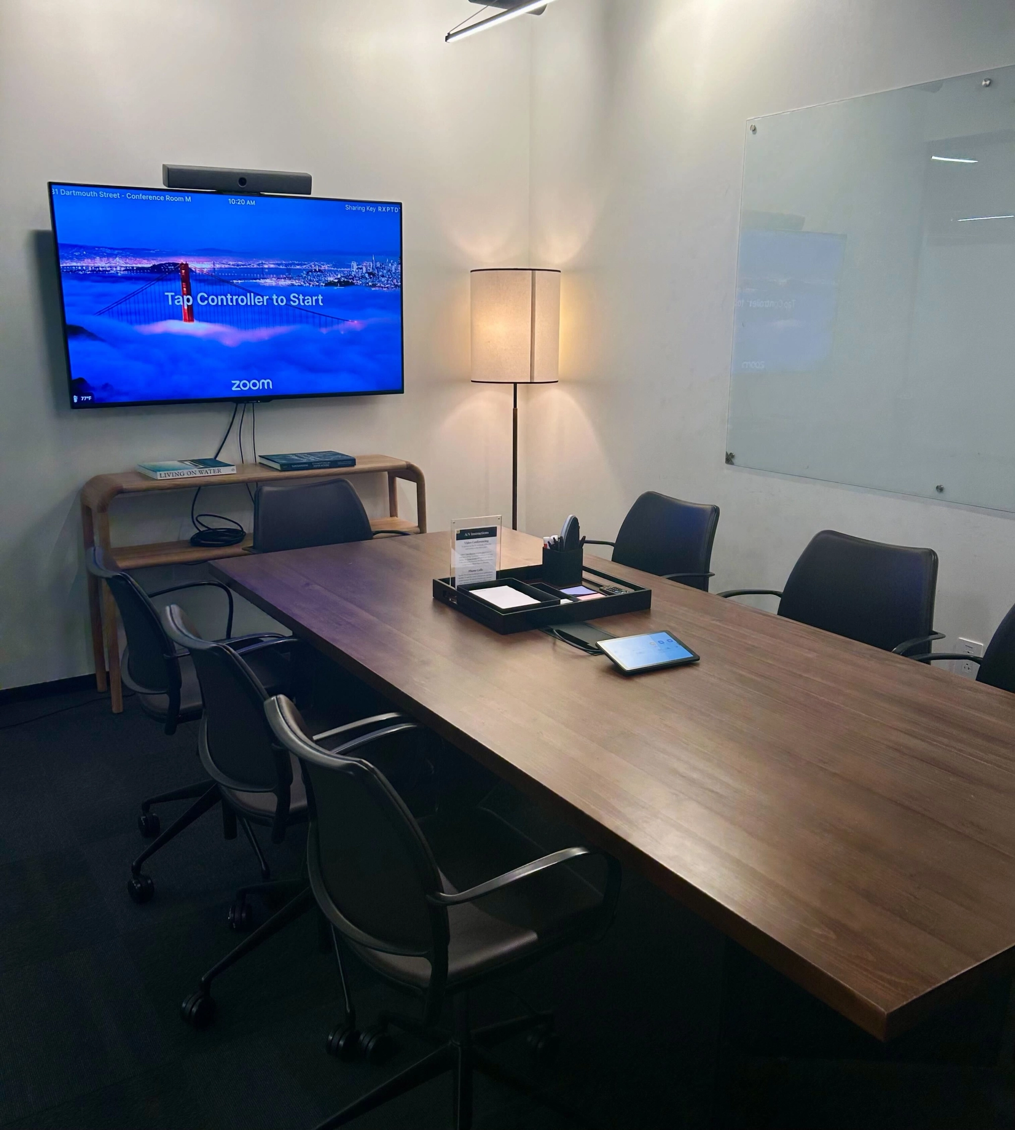 Modern office conference room equipped with a video conferencing system.