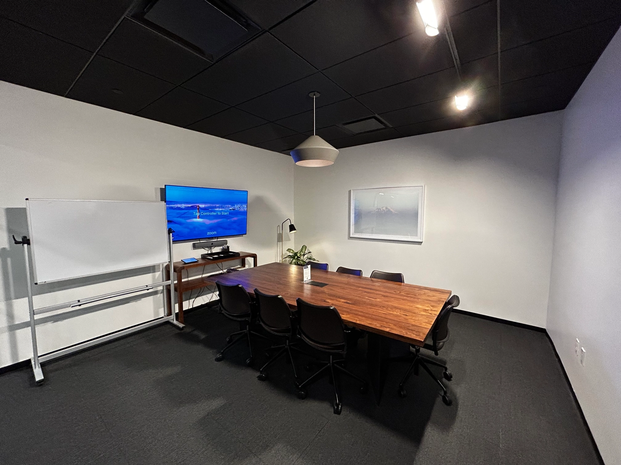 A New York office workspace furnished with a table and chairs.