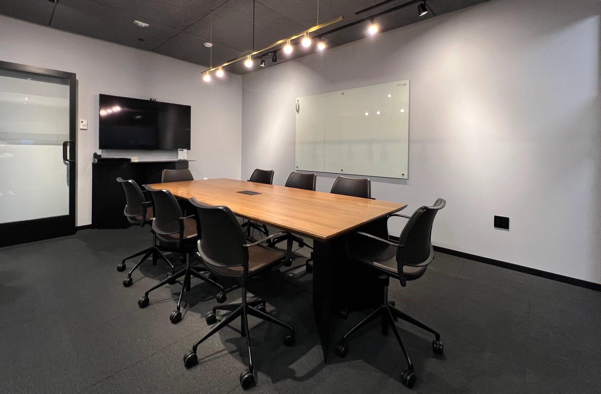 A coworking space equipped with a wooden conference table and chairs.