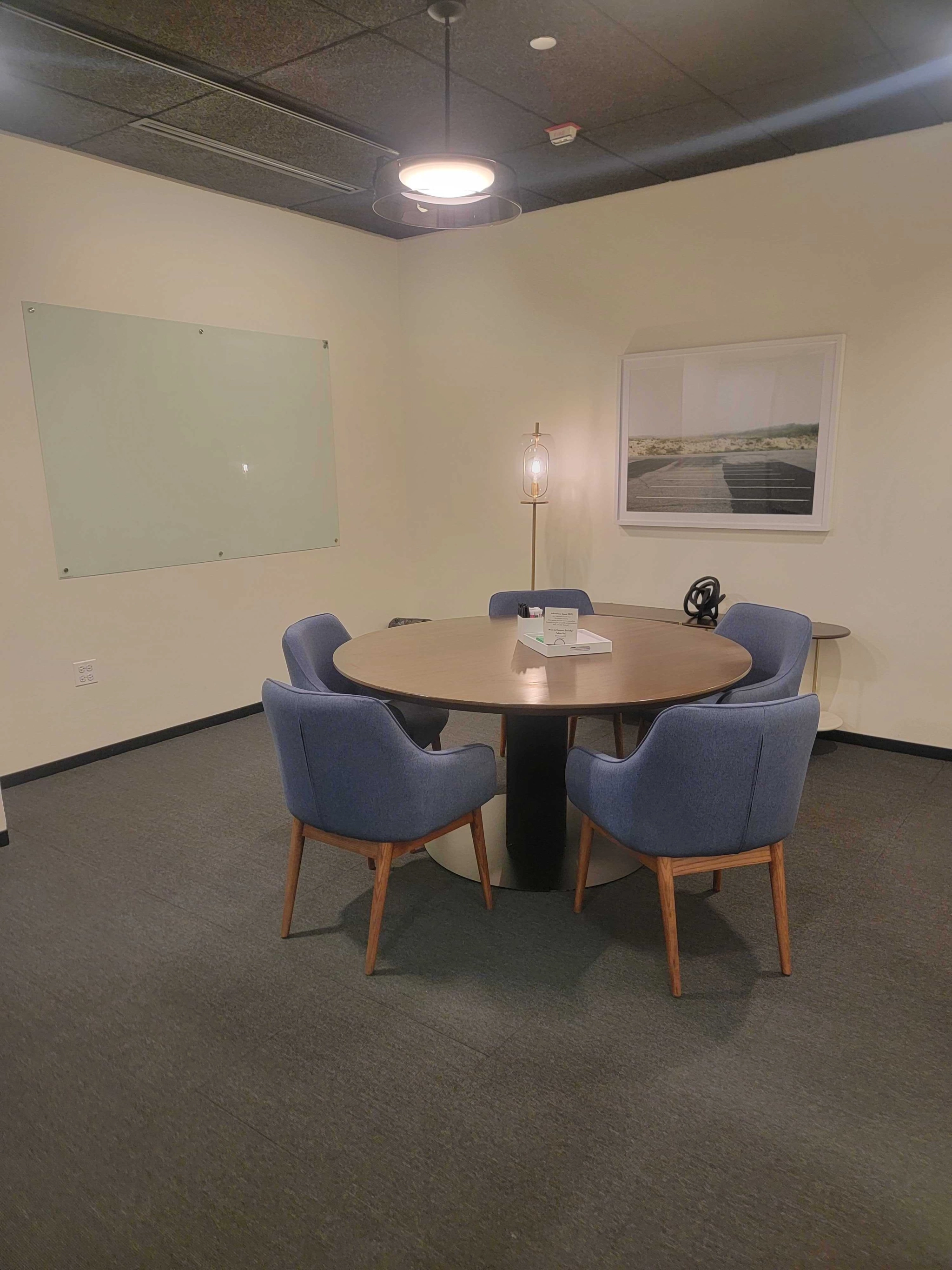 A Chicago meeting room boasting a round table and chairs.