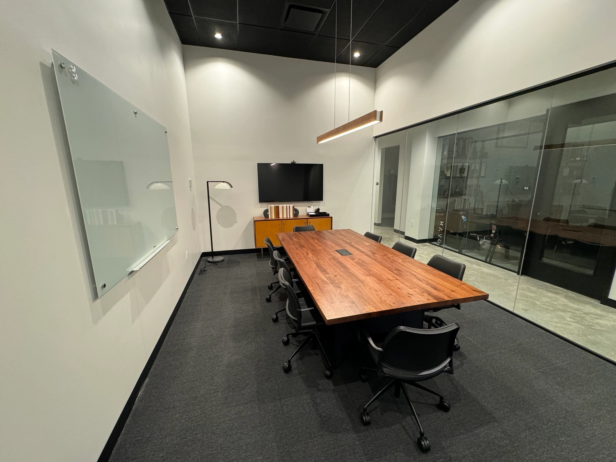 Aventura workspace featuring a conference room with a wooden table and chairs.