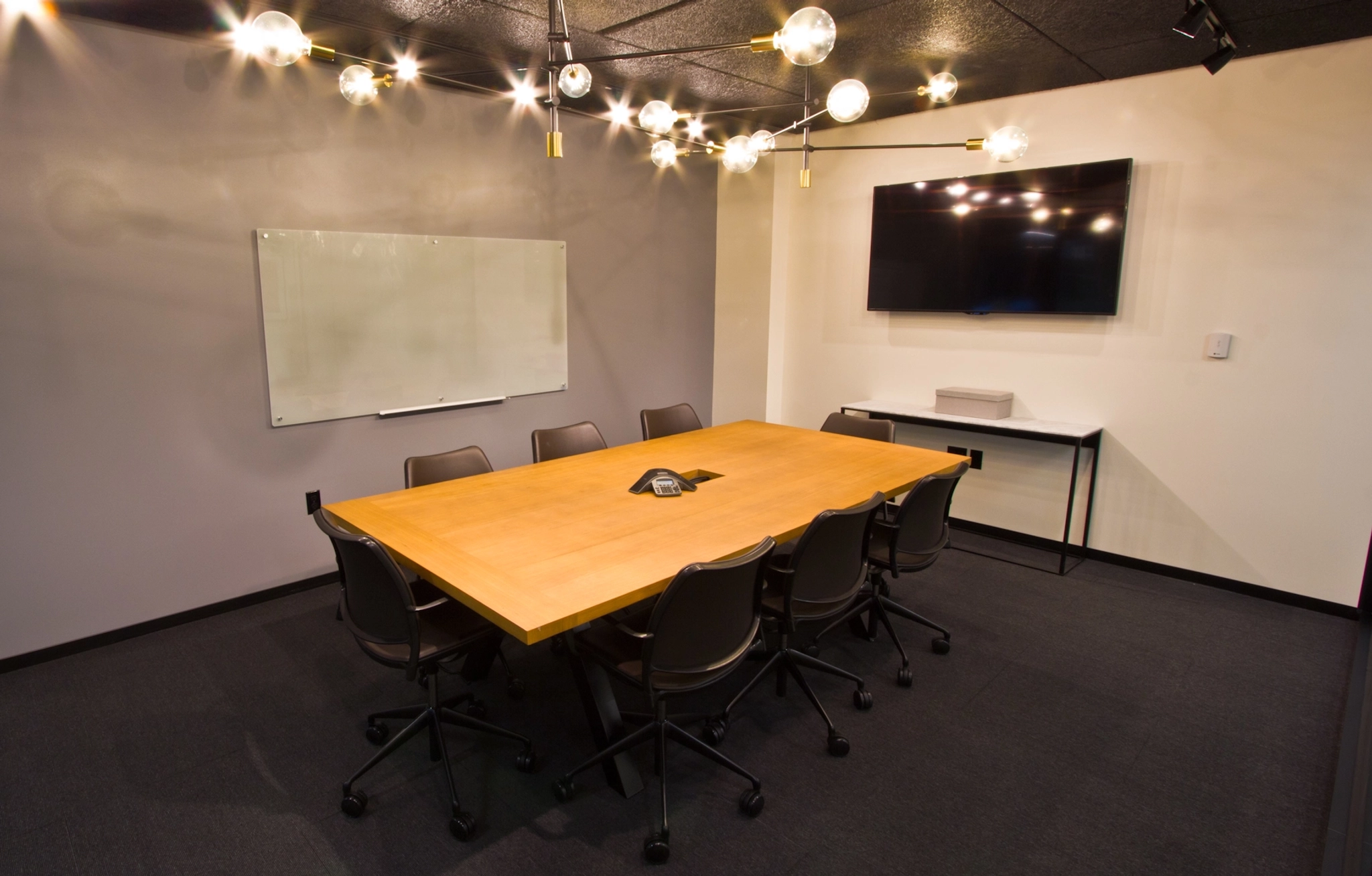 An office conference room furnished with a table and chairs.