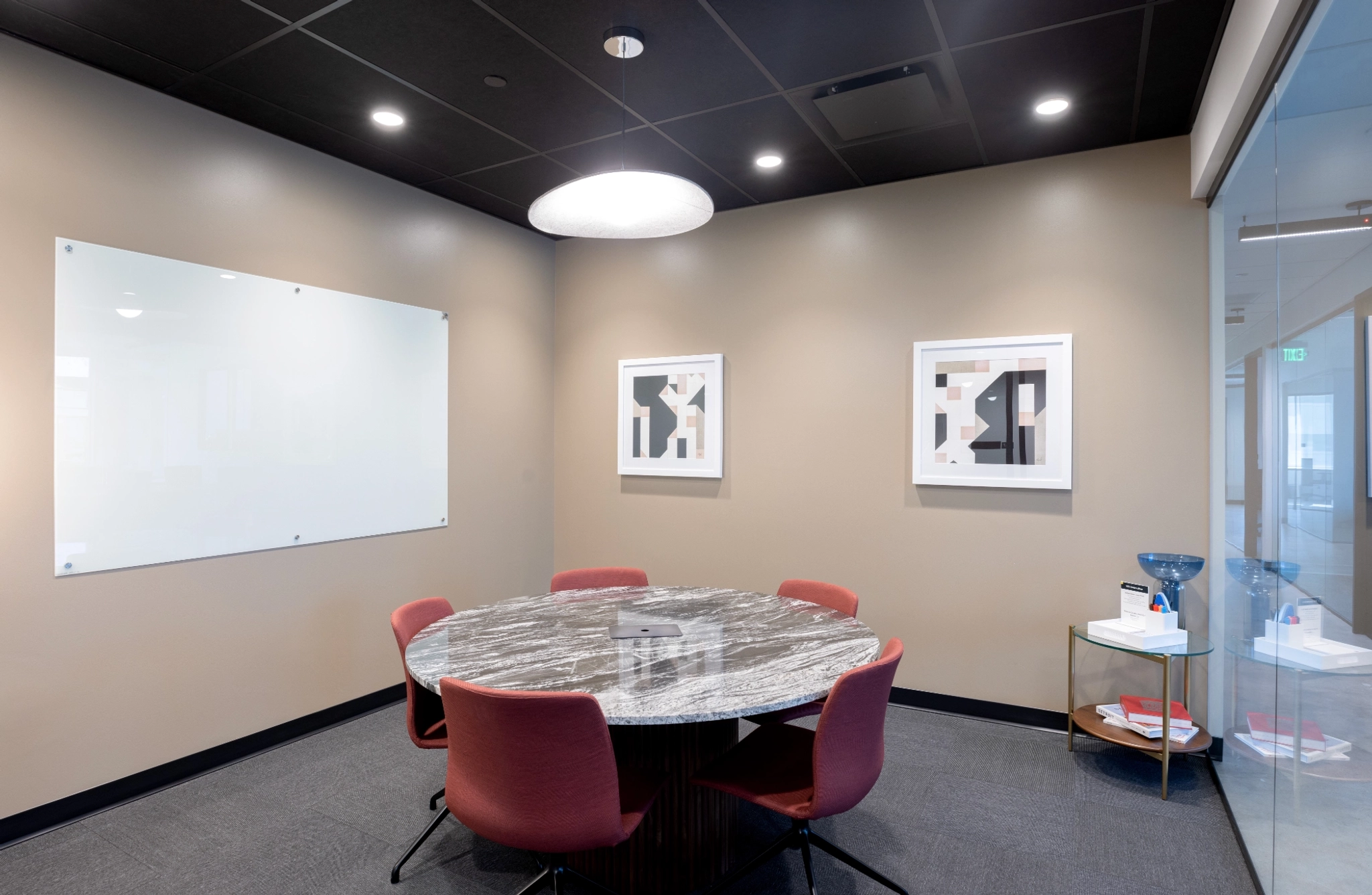 A coworking meeting room in Houston, equipped with a table and chairs.