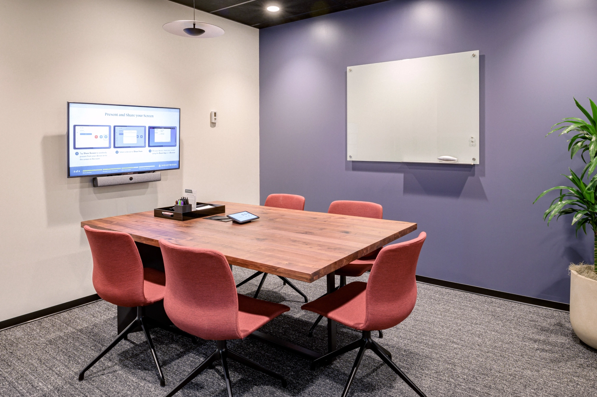 A Toronto meeting room with a tv and chairs, providing a versatile workspace for your needs.