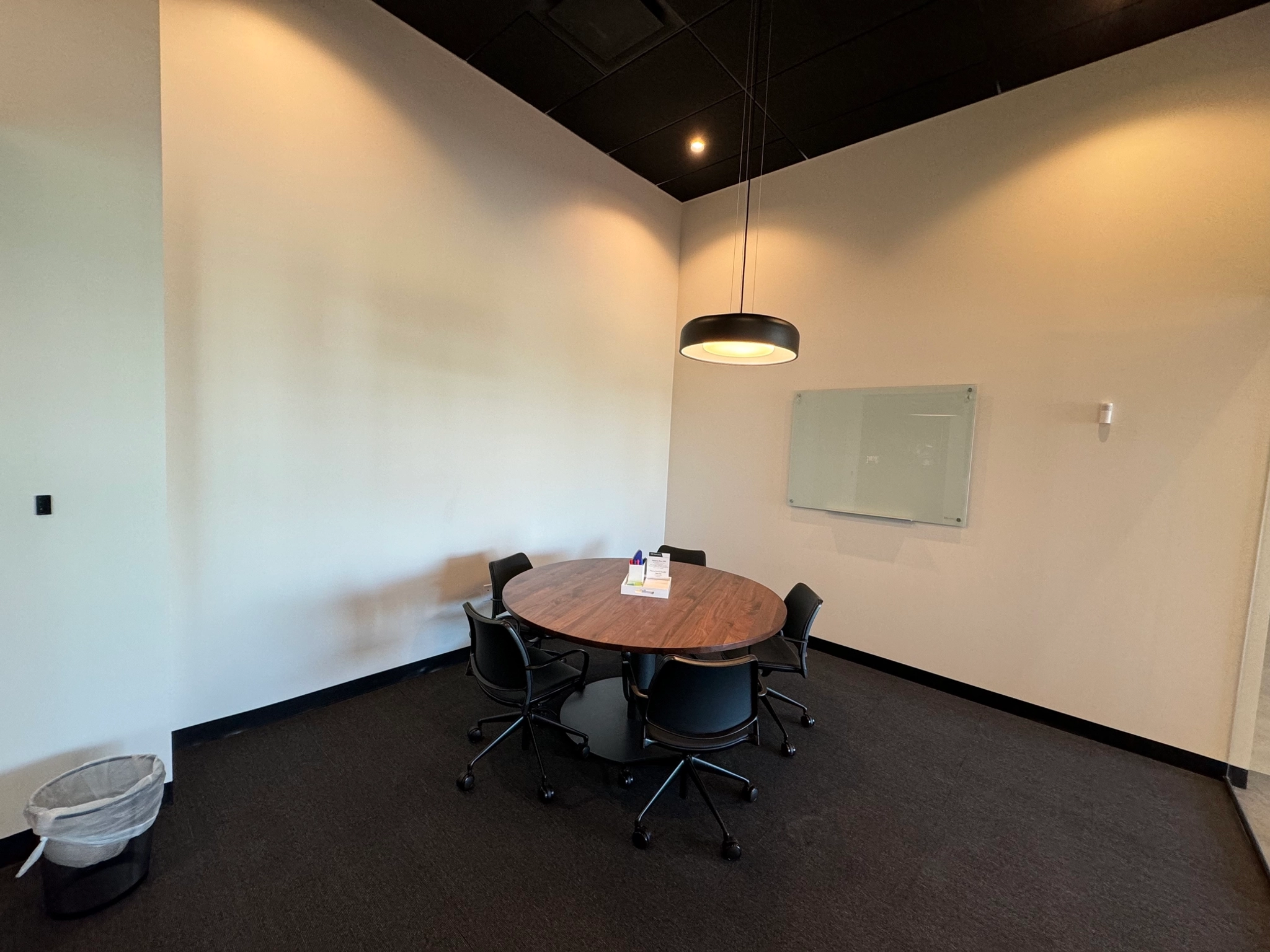 A coworking conference room with a round table and chairs.