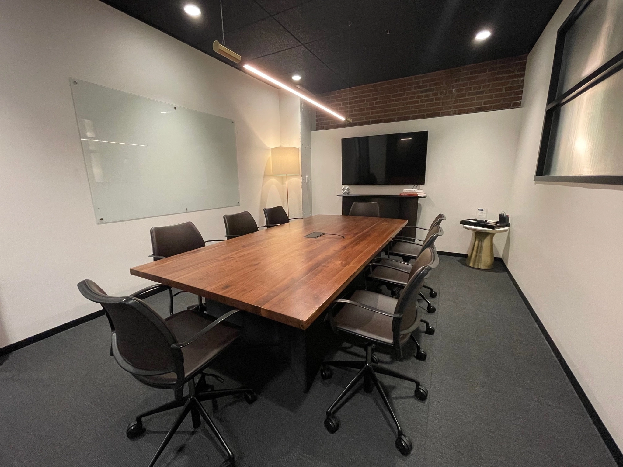 A coworking space in Kansas City equipped with a wooden table and chairs for conference meetings.