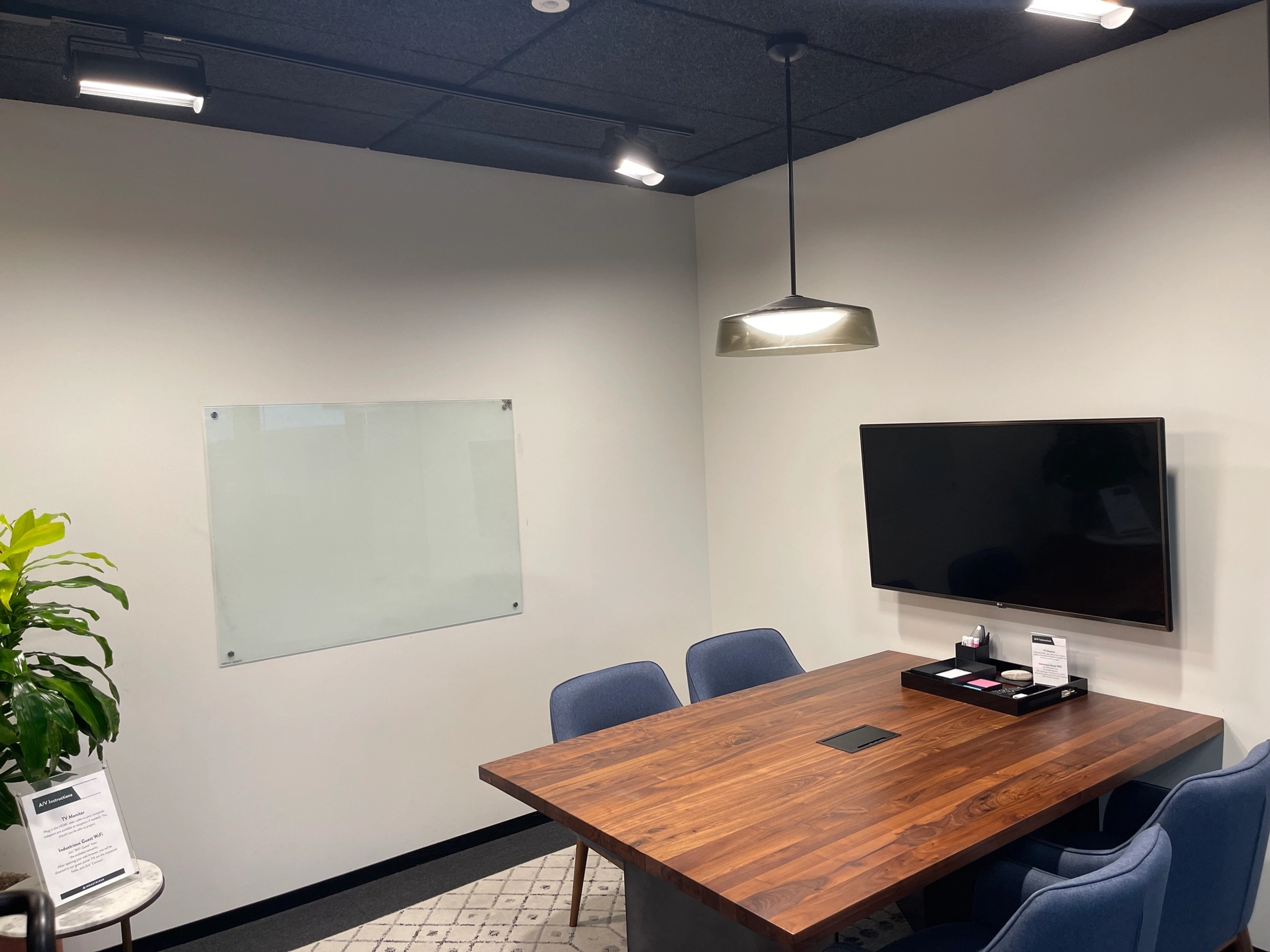 A conference room in an office located in Los Angeles, equipped with a table, chairs, and a TV.