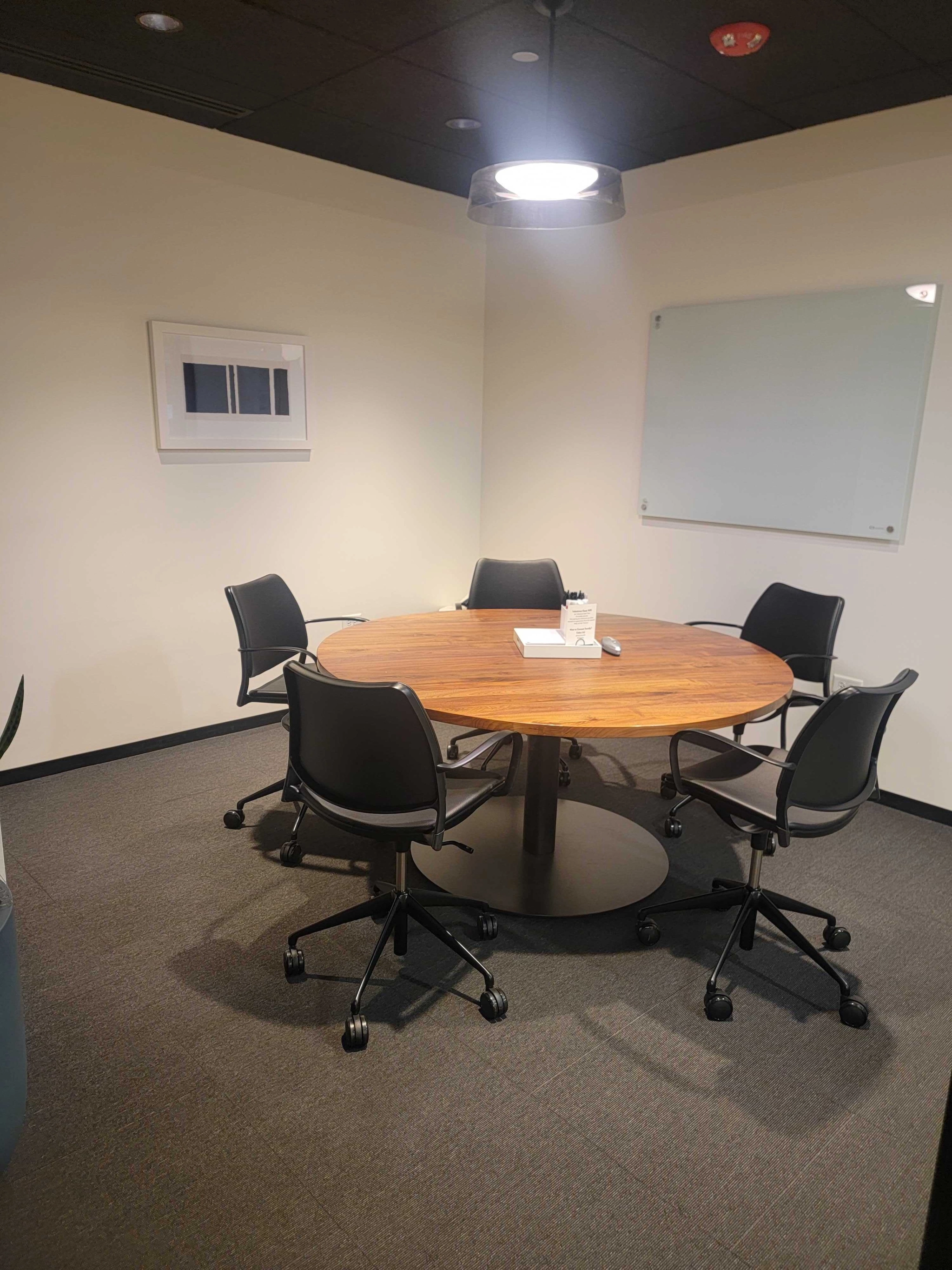 A coworking office in Chicago with a round table and chairs for conferences.