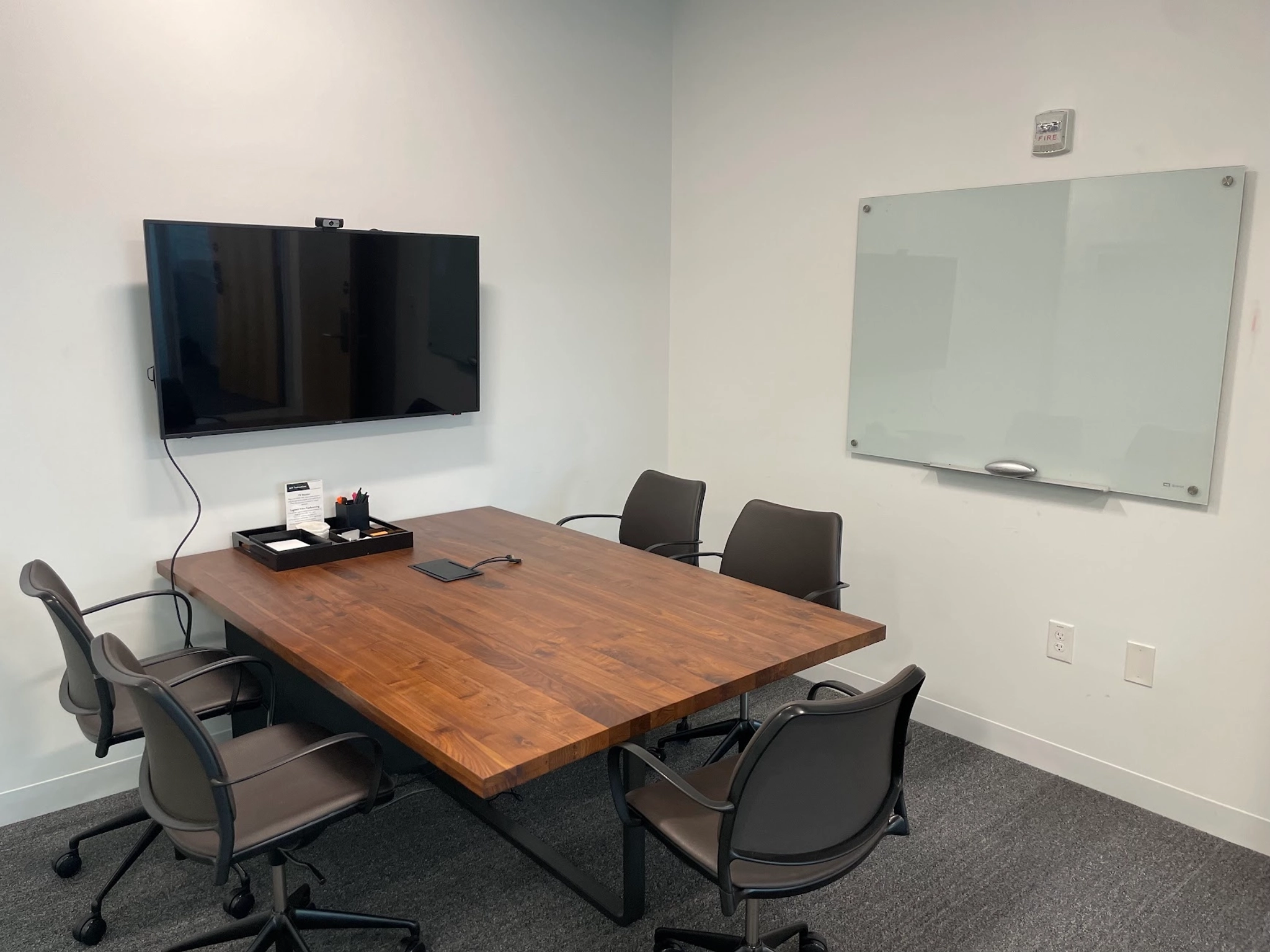 Een kantoorvergaderruimte in Atlanta uitgerust met een tafel, stoelen en een televisie.