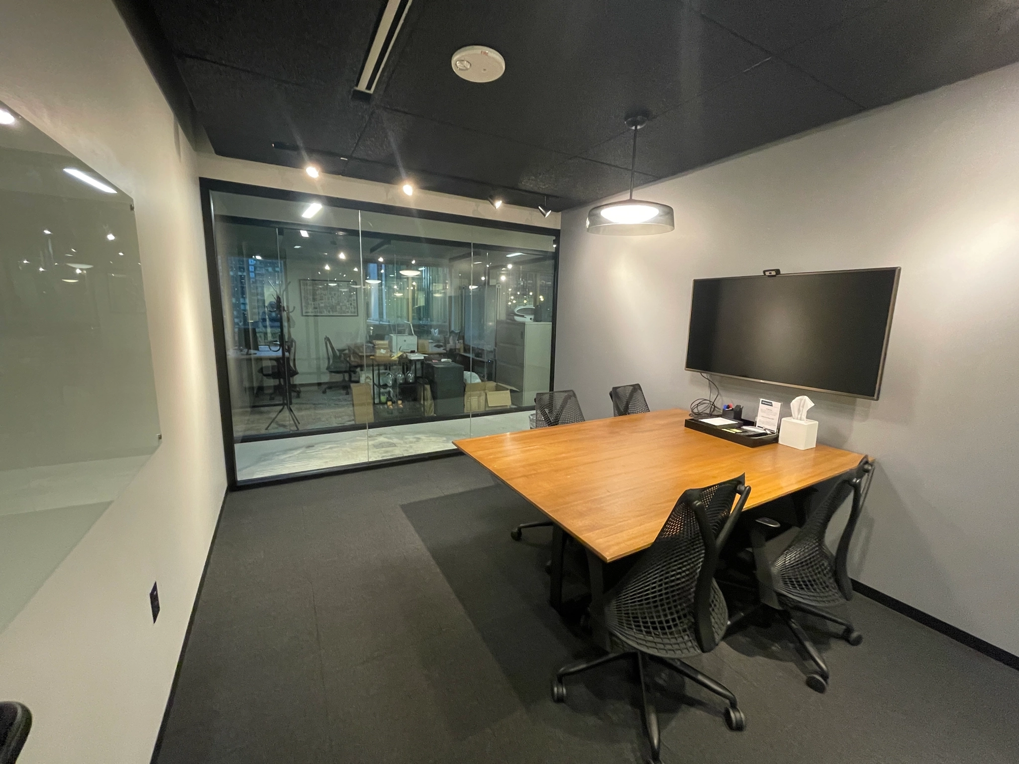 A coworking meeting room in Seattle equipped with a table and chairs.