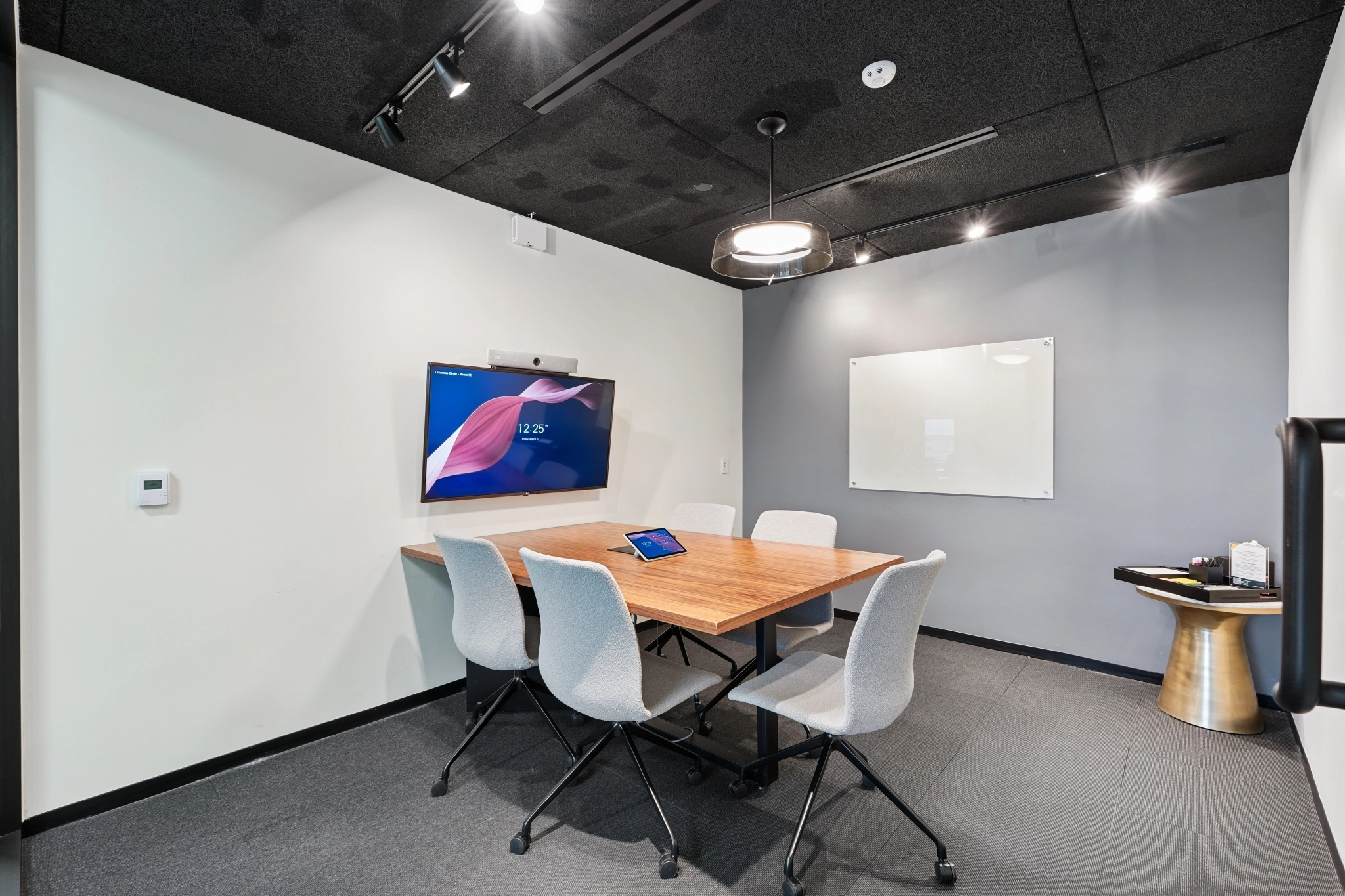a large, bright meeting room with a large screen